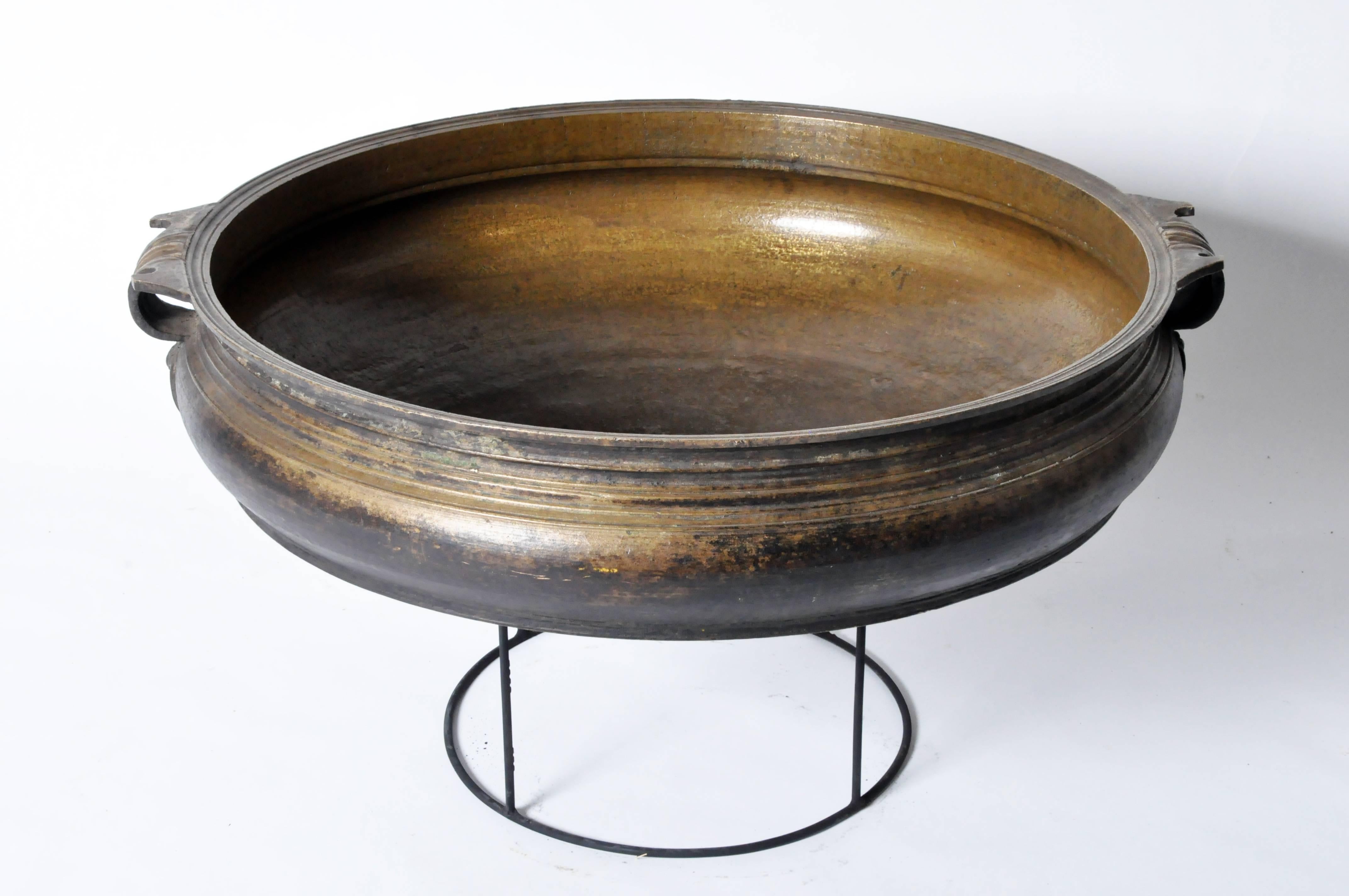Raised on a newly made custom metal Stand, this large bowl-like censer has a banded decoration throughout the body and along the rim. The two loop handles with talon shaped decoration terminate in cordiform plates. Traditionally made for cooking, it