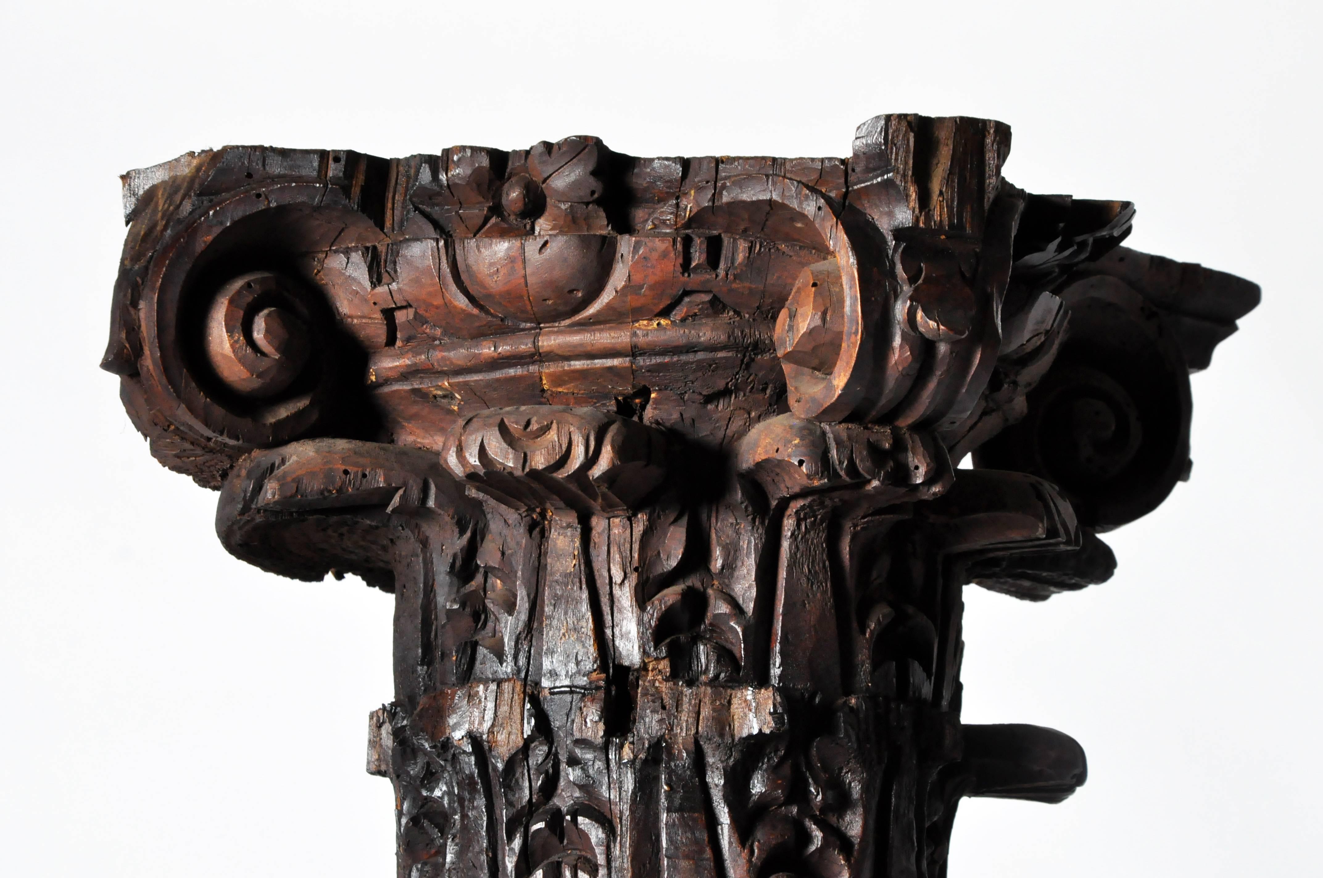 Beautifully hand-carved Corinthian capitals with scrolling acanthus leaves surmount the twisted beanstalk-like shafts of these columns. The winding central stems of each are intricately decorated with lifelike figures of birds and leafy grapevines