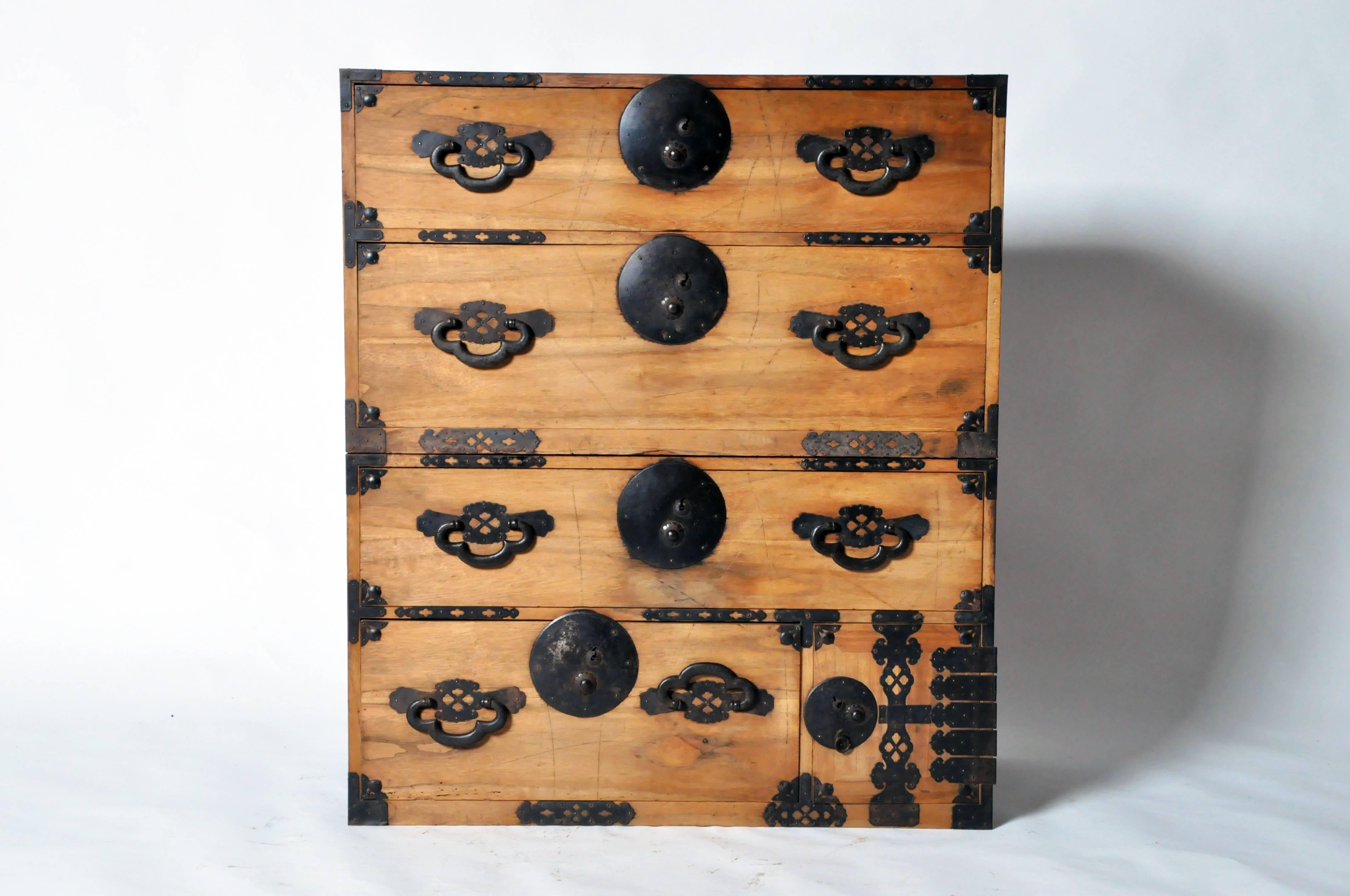 This handsome Japanese Tansu is from Kyoto, Japan and features four drawers and detailed lock plates. The tansu chest can be unstacked and one of the pieces is outfitted with a small door covering a secondary compartment. 

The pair’s size makes