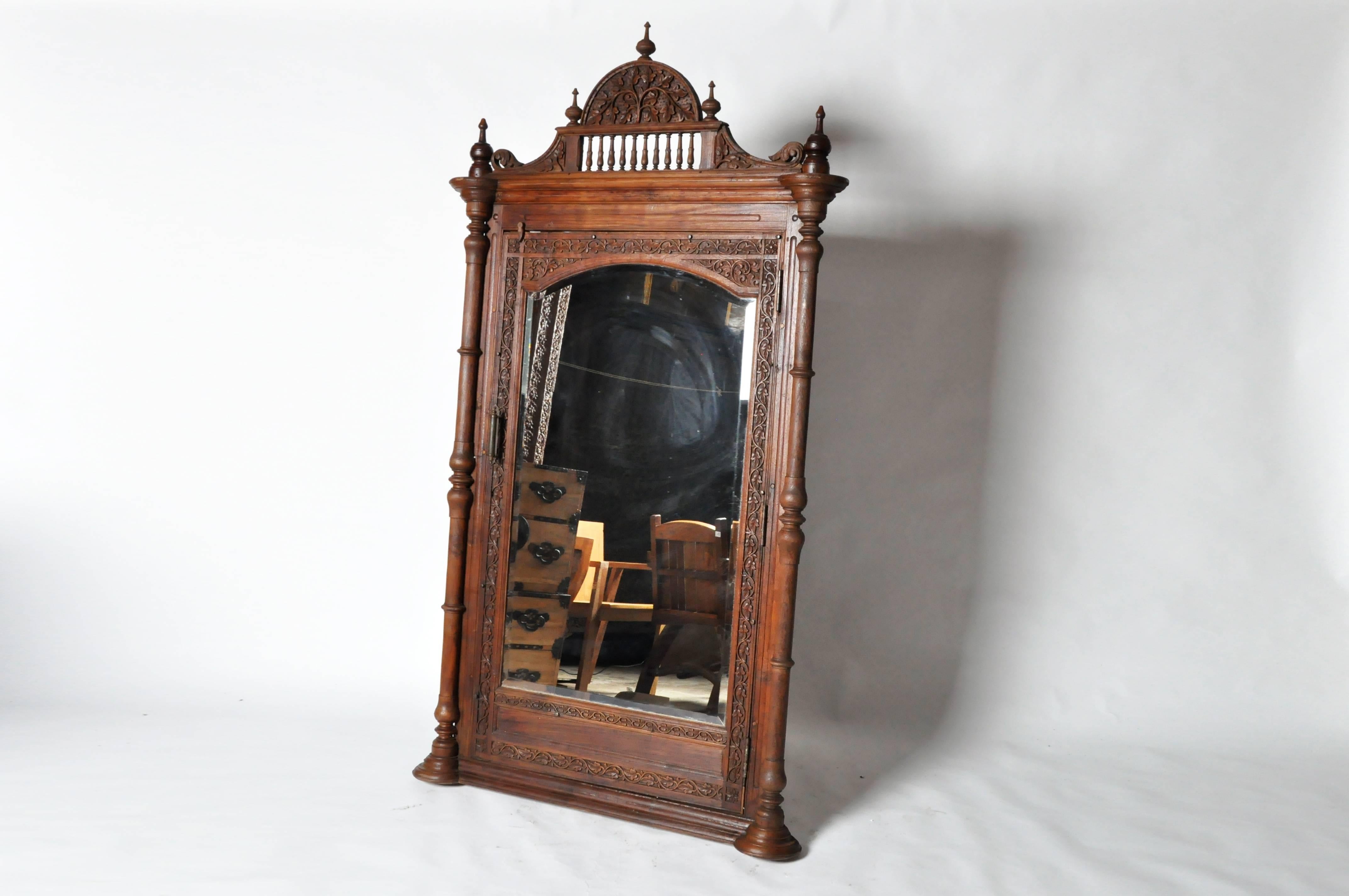 This British Colonial mirror features beautifully hand-carved teak wood and is from Gujarat, India early 20th Century.