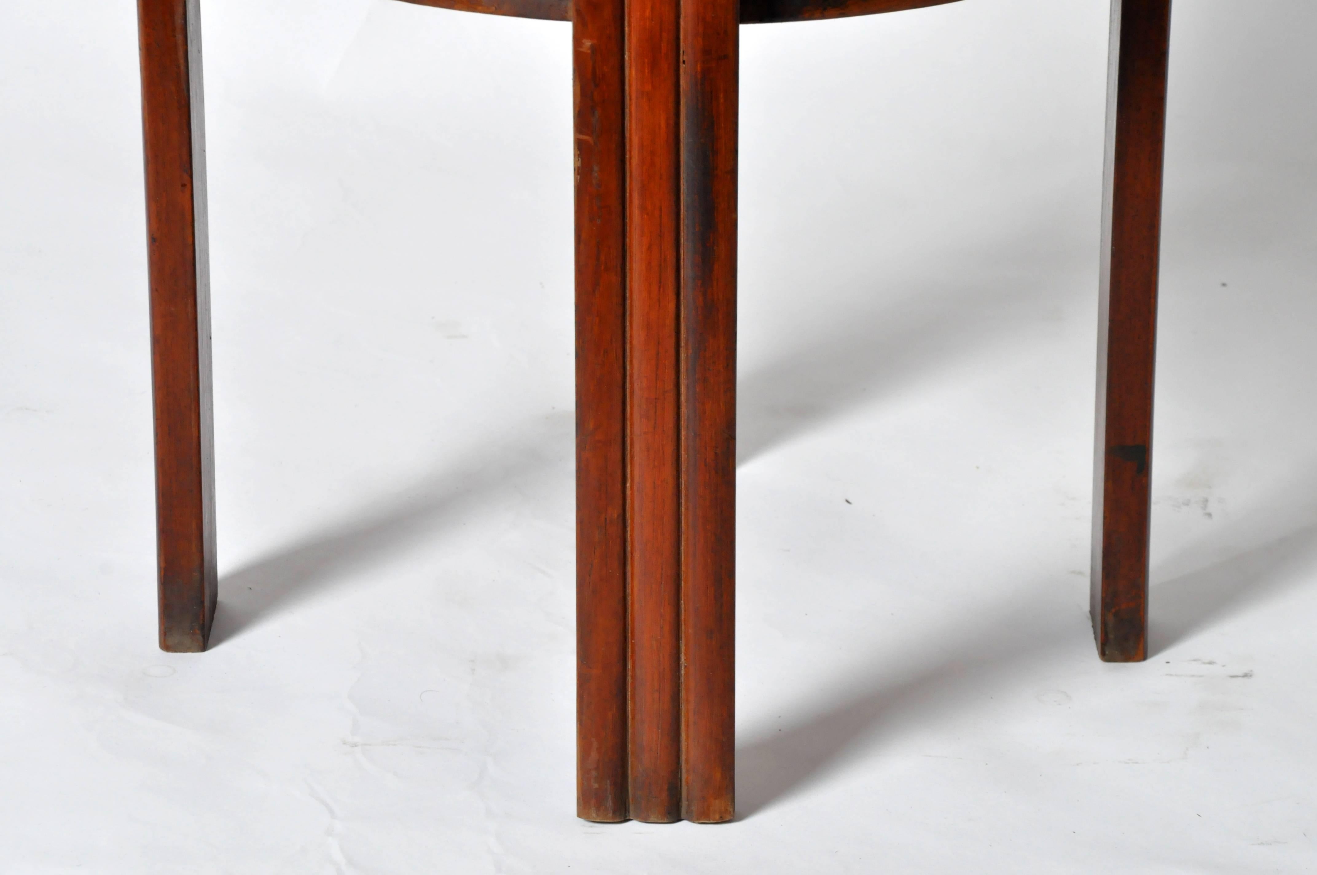 This Art Deco round table is from Myanmar and is made from teakwood. It can function as a side table, end table, or a pedestal.