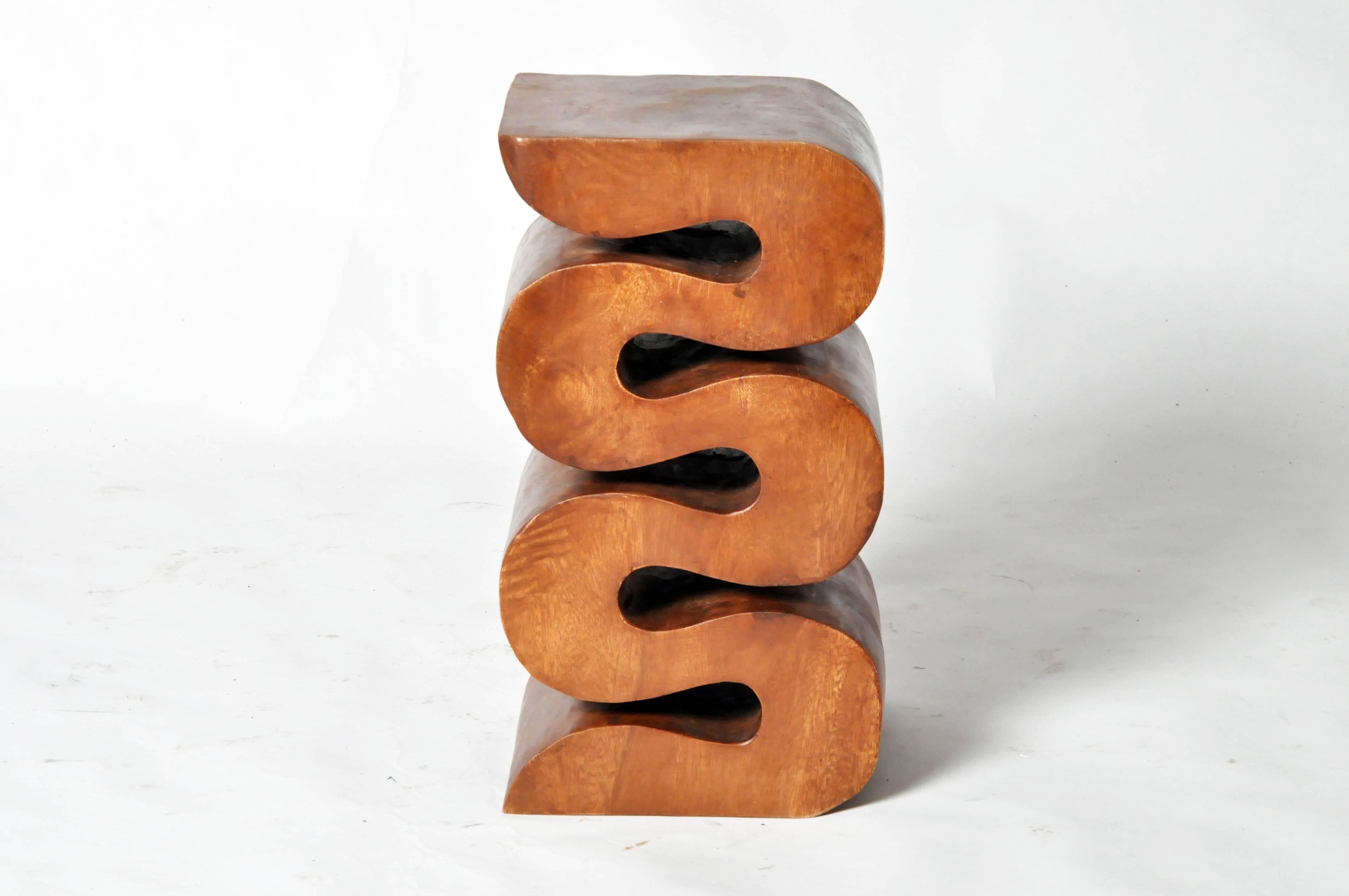 This recently handmade snake stool made from acacia wood and is from Thailand.