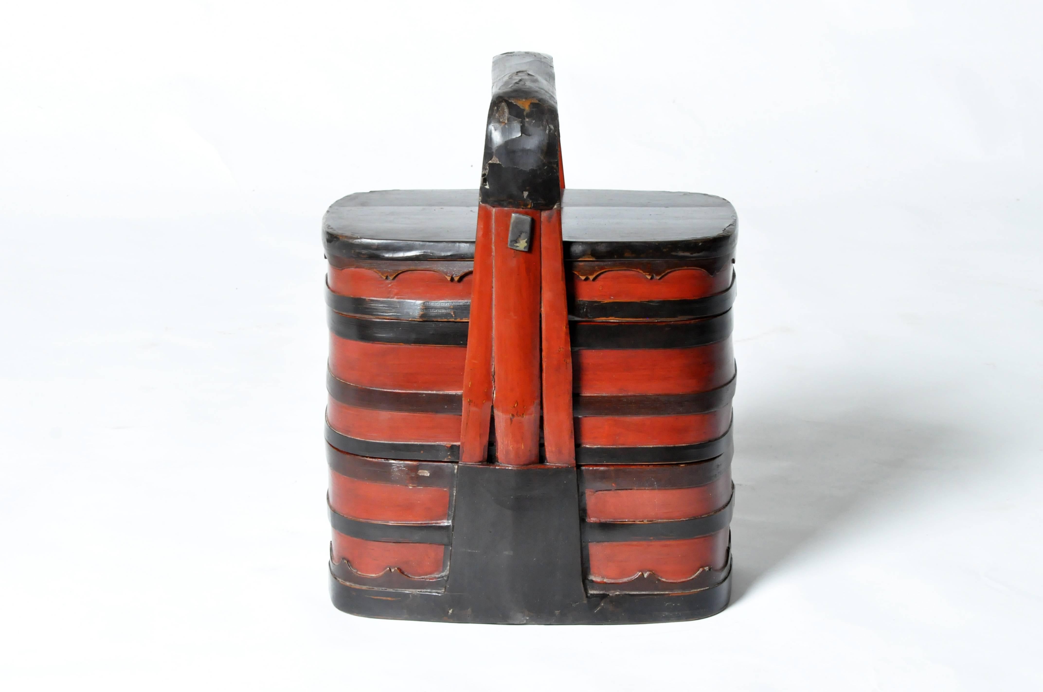 This Chinese food carrier is from Fujian, China and made from lacquered bamboo.