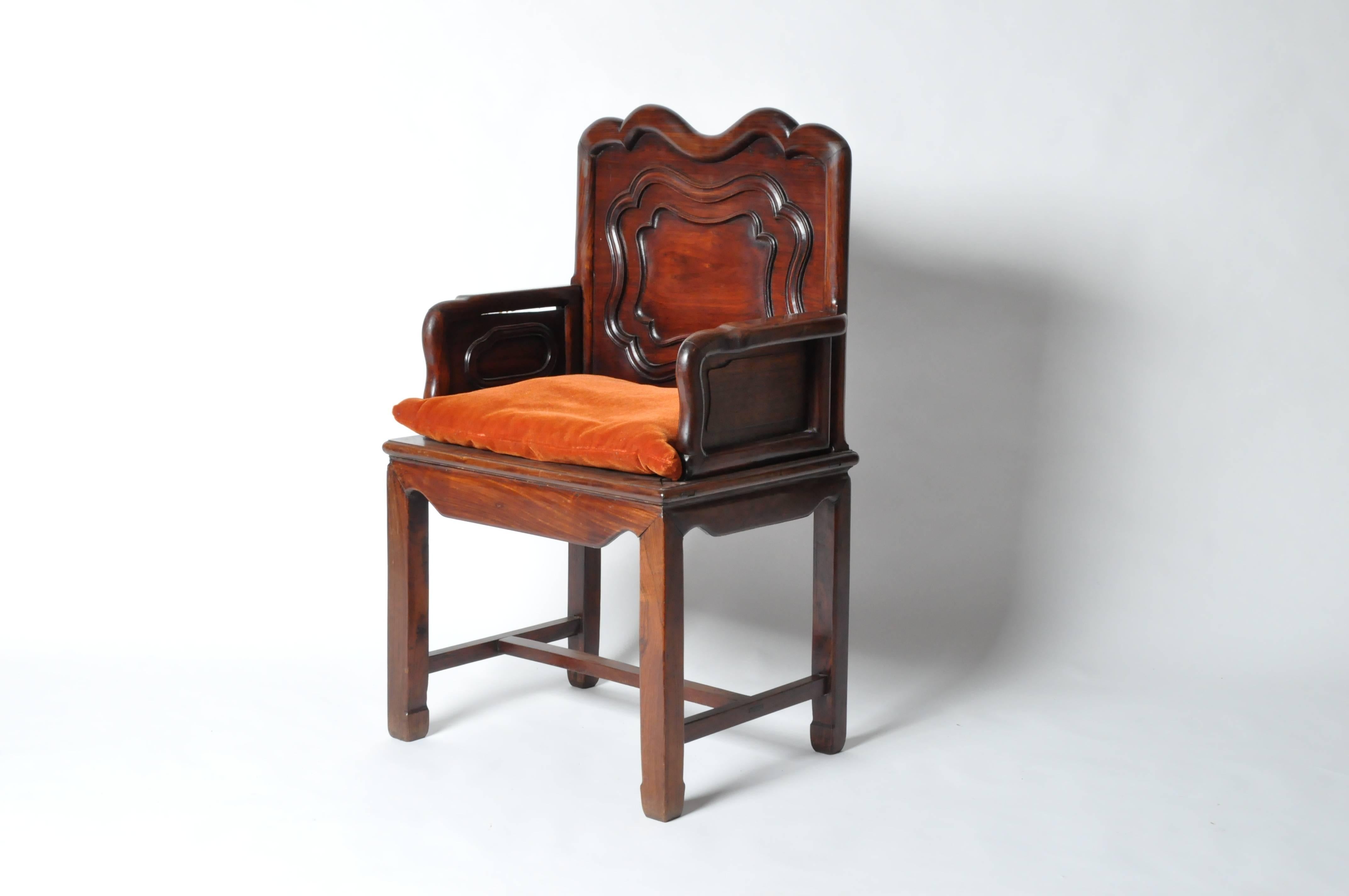 This pair of Chinese hardwood armchairs are made from rosewood, early 20th century and are from Shanghai, China. Excellent wood color, solid arms and delicately carved center medallions give this pair of chairs great presence. Seat cushion is added;