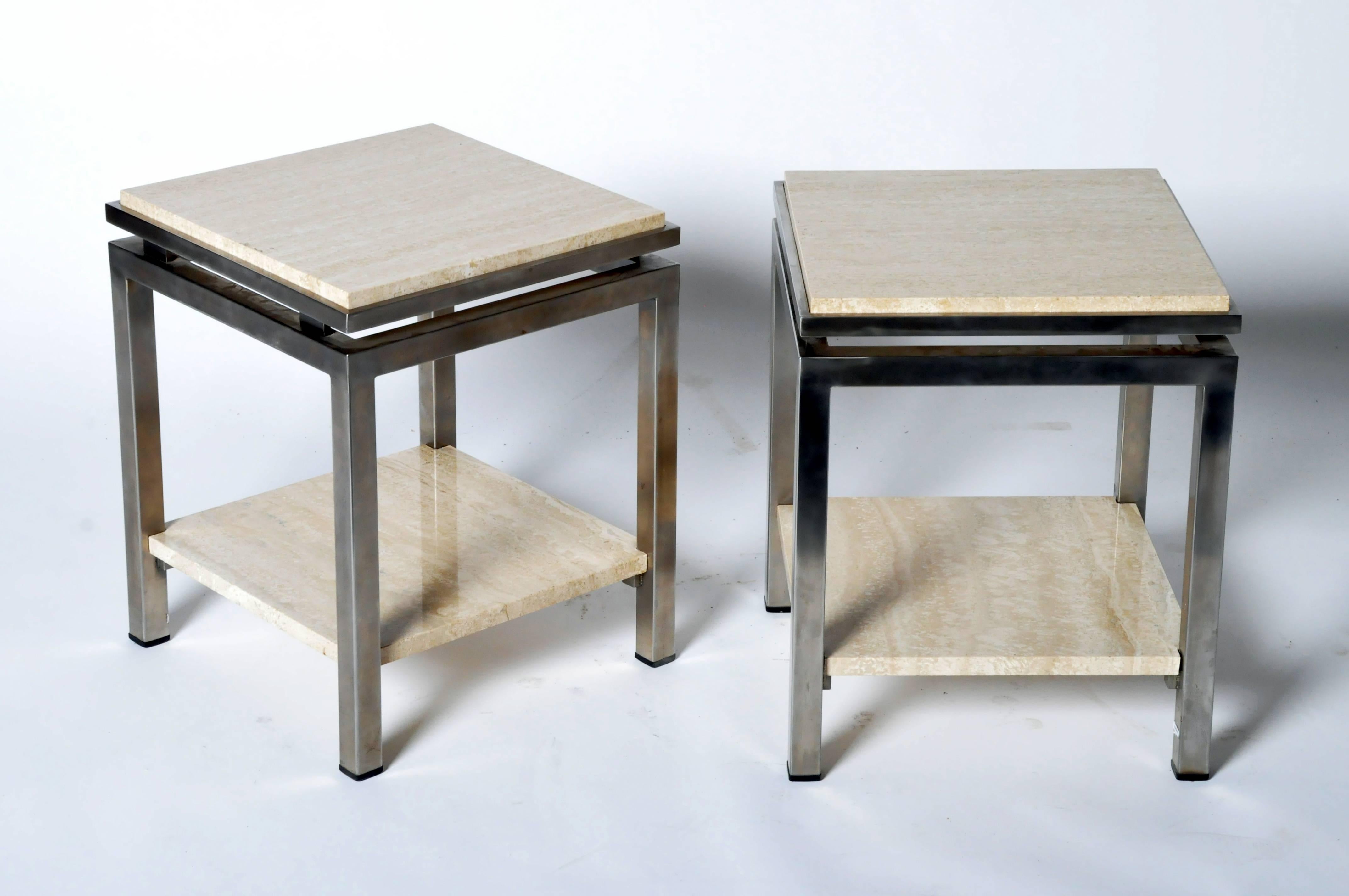 These Mid-Century Modern French end tables have Lefevre’s flair for the exotic as seen in their waisted tops and square-corner frames. Handsome brushed metal encloses the marble inset tops, which surmount the unframed stone shelves below.