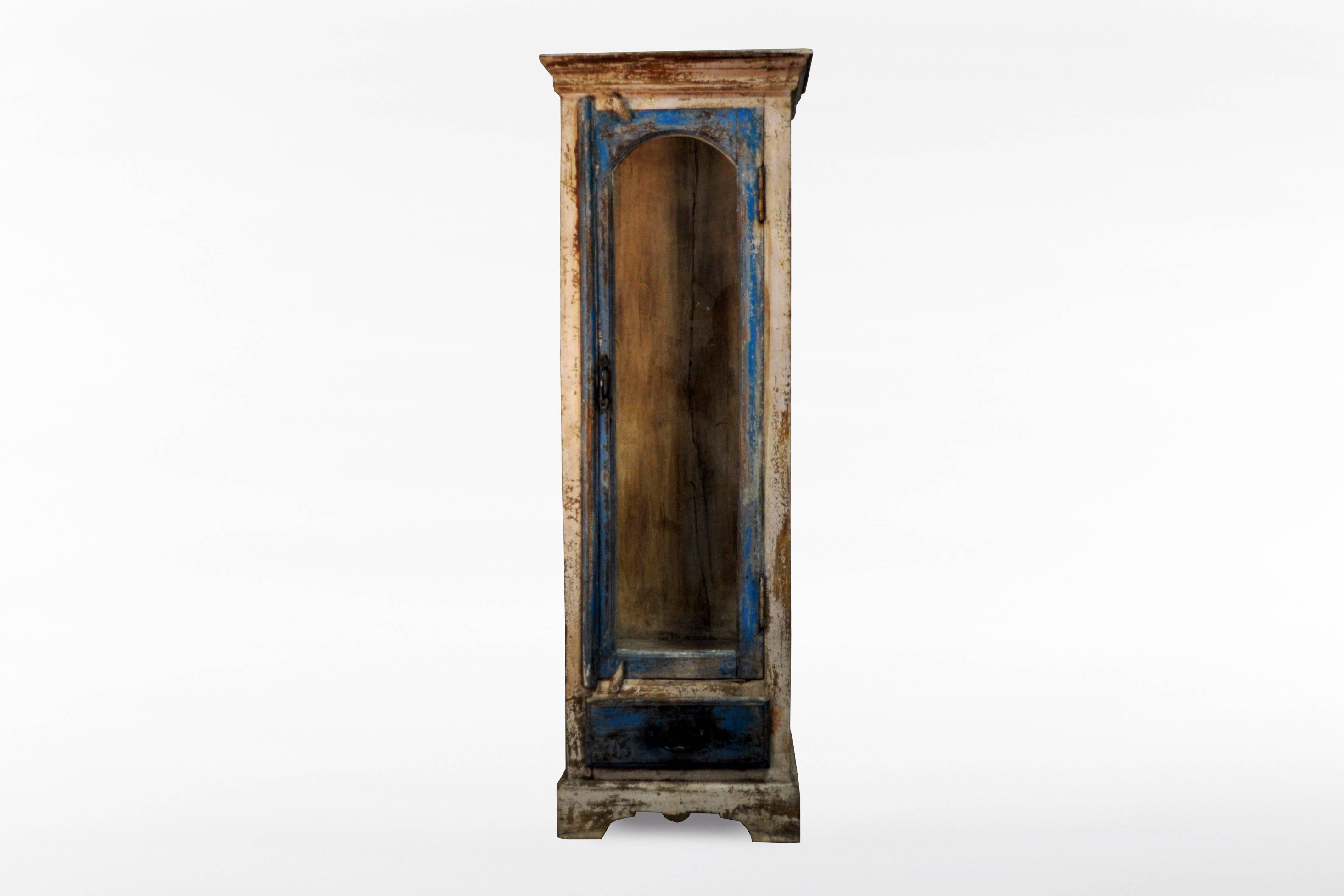 This inexpressive painted display cabinet is from India and is made from chechum wood, circa 1950.