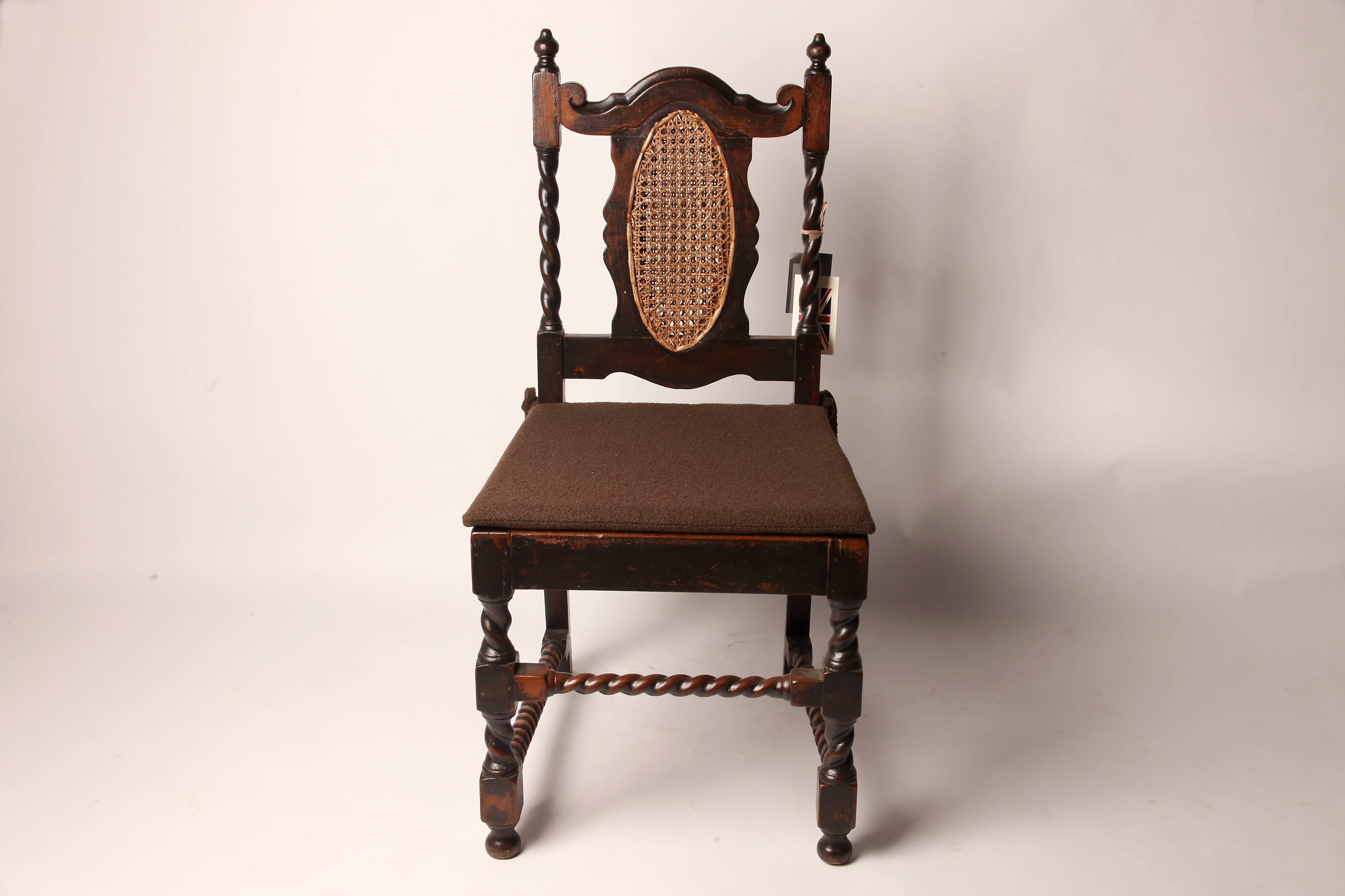 These British colonial side chairs are from India and made from teakwood. They feature rattan and barley twist spindles.