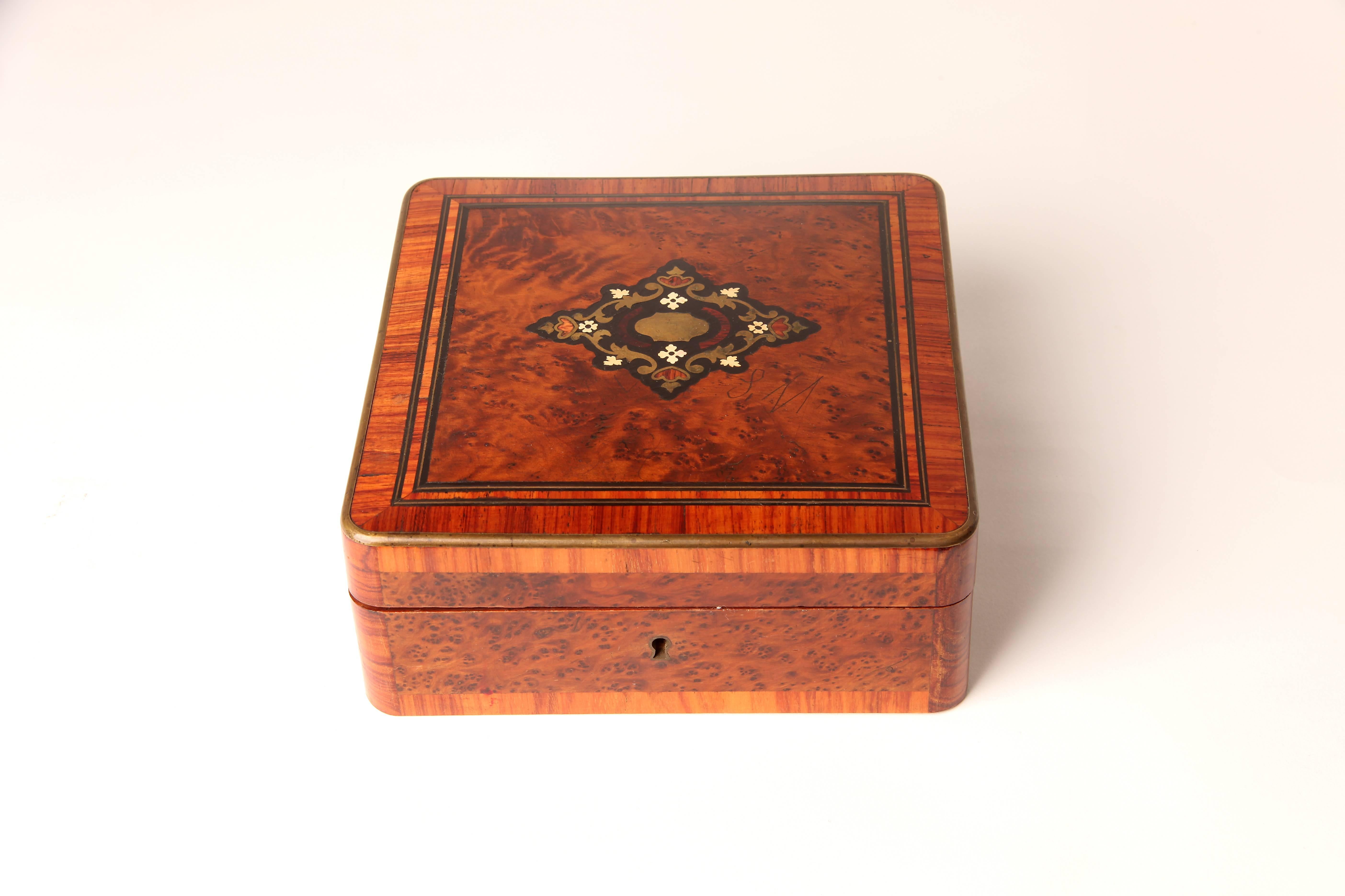 This elegant jewelry box is from France and is made from amarante veneer, circa 1900.