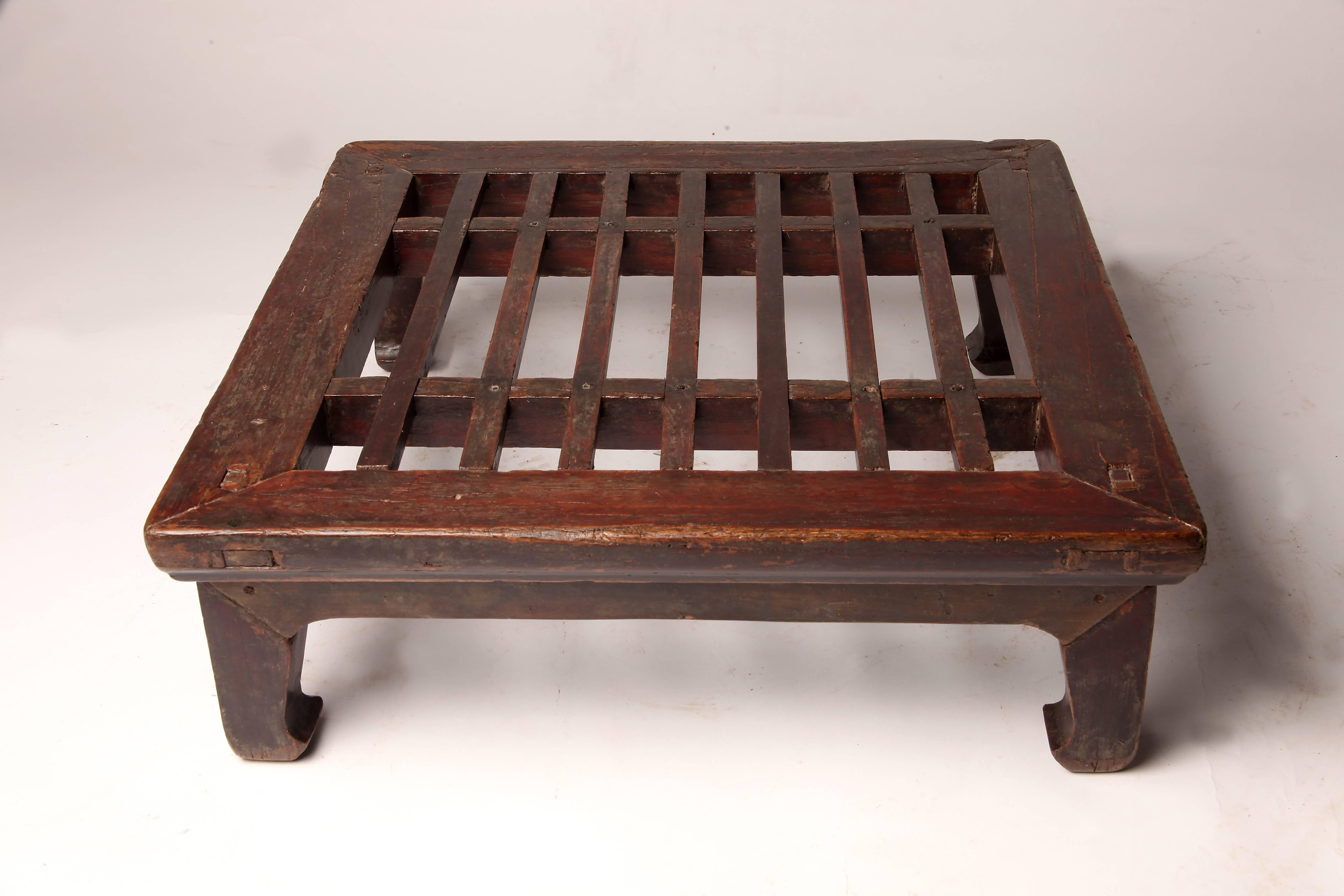This foot stool is from China and is made from elmwood, circa 1880.