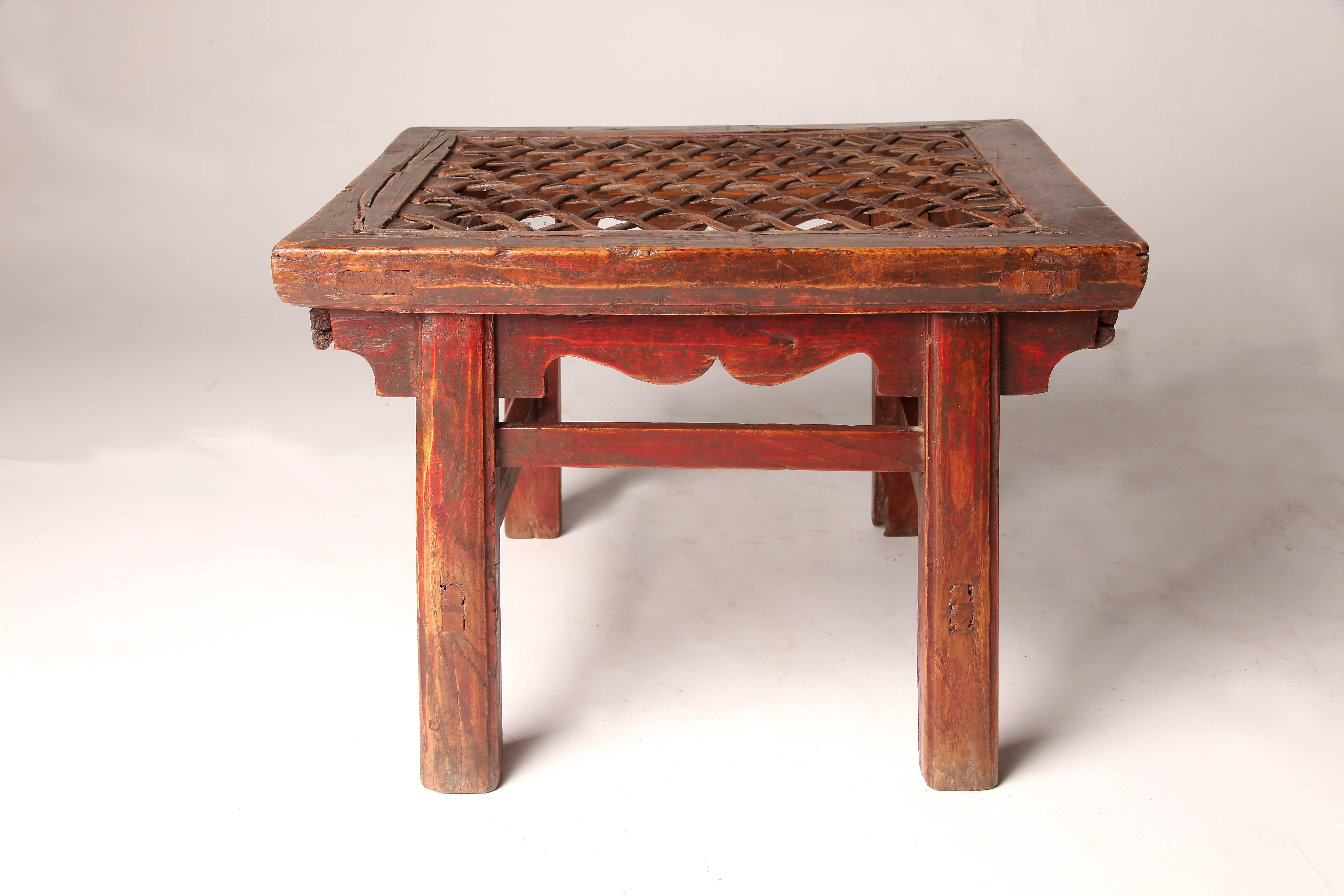 These Chinese stools are made from elmwood and features woven leather seats.