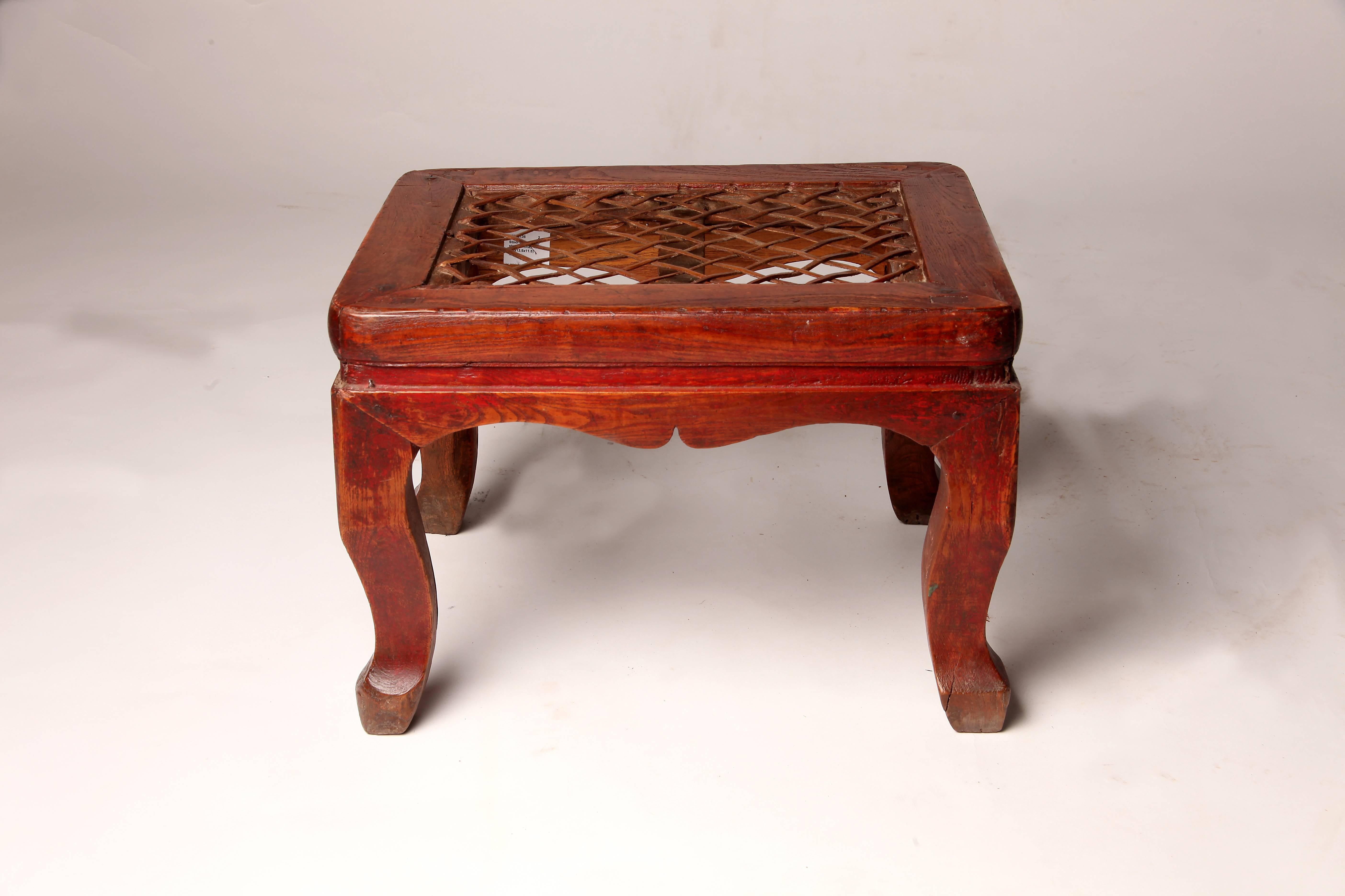 These Chinese stools are made from elmwood and features woven leather seats and cabriole legs.