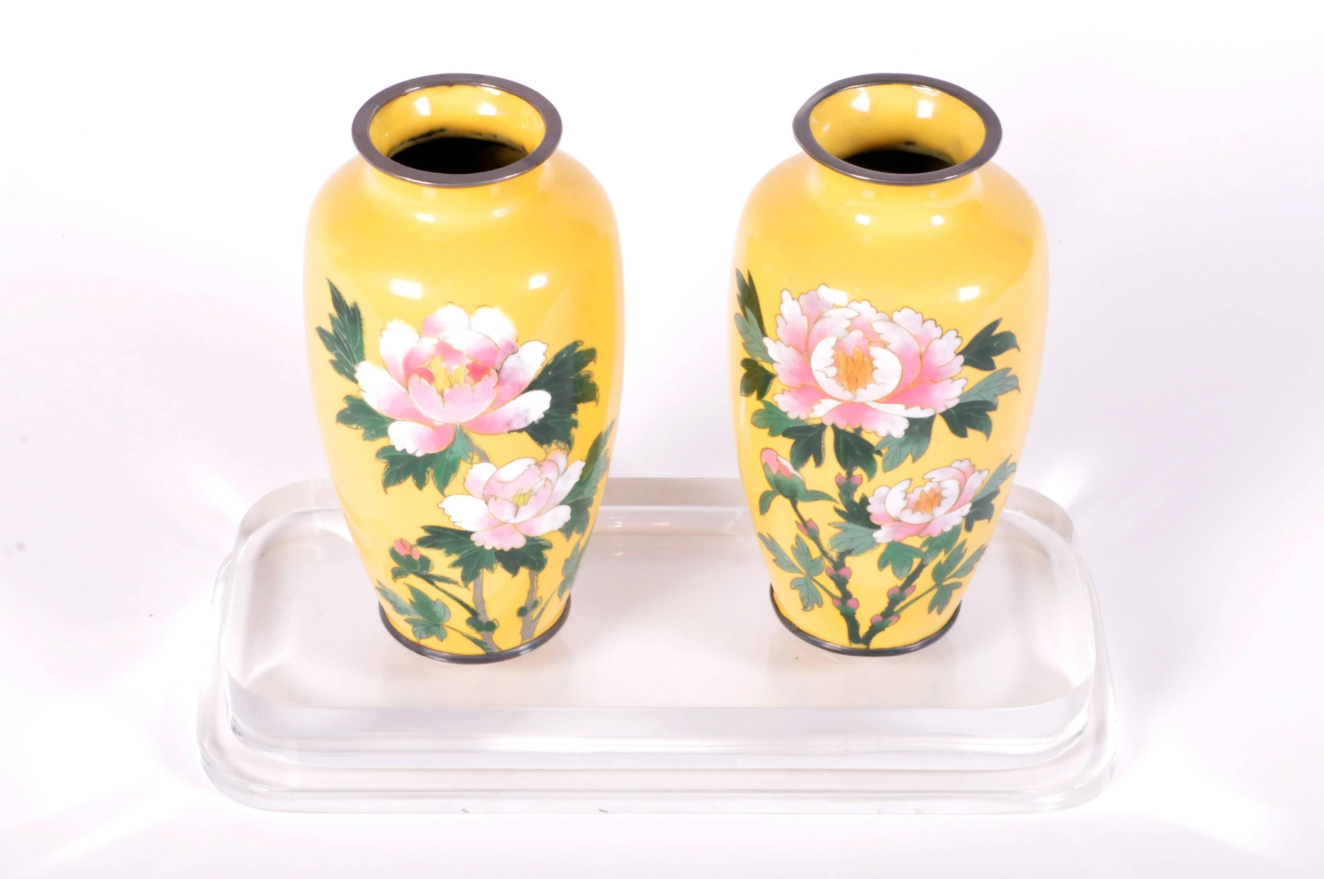 This pair of Japanese cloisonné vases are made from ceramic circa 1940 and they feature peony motifs.