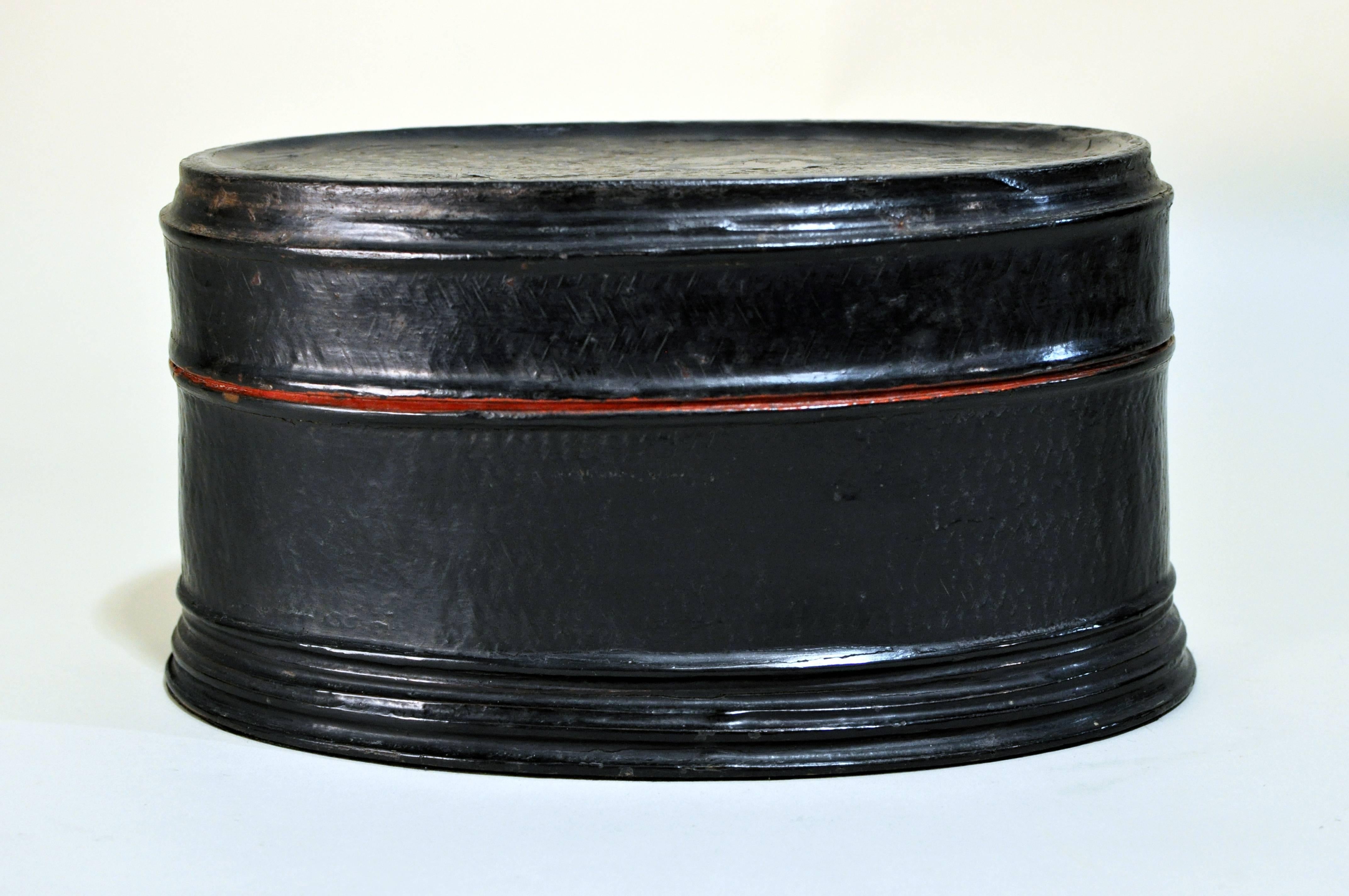 This oval lacquer ware box is from Chiang Mai, Thailand and is made from bamboo and lacquer.