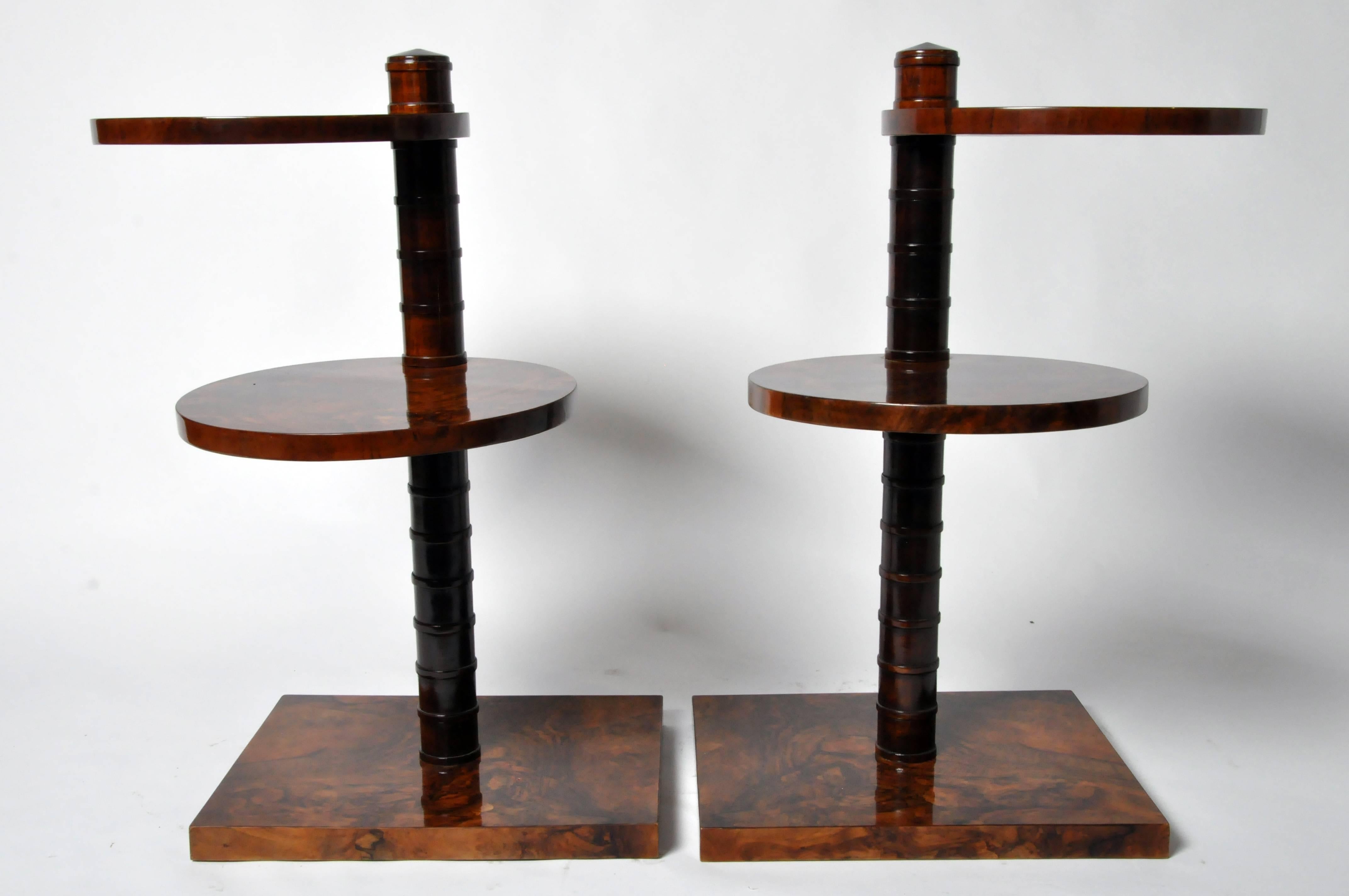 This pair of side tables is from Hungary and is made from walnut veneer, circa 1940. They each feature a base and two rotatable shelves.