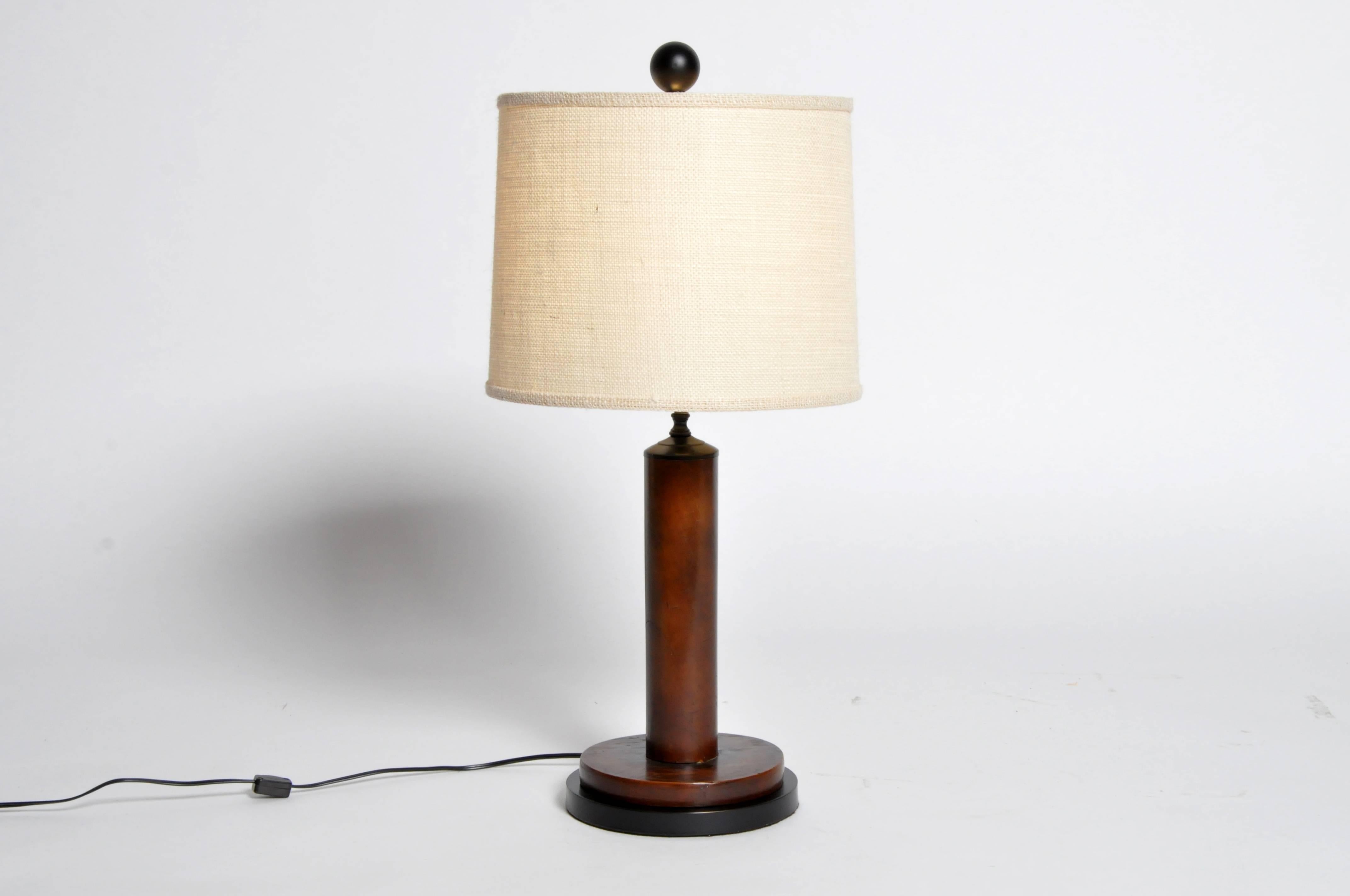 These simple British Colonial teak wood lamps retain their original varnish. They have been rewired and fitted with modern shades and lamp hardware.