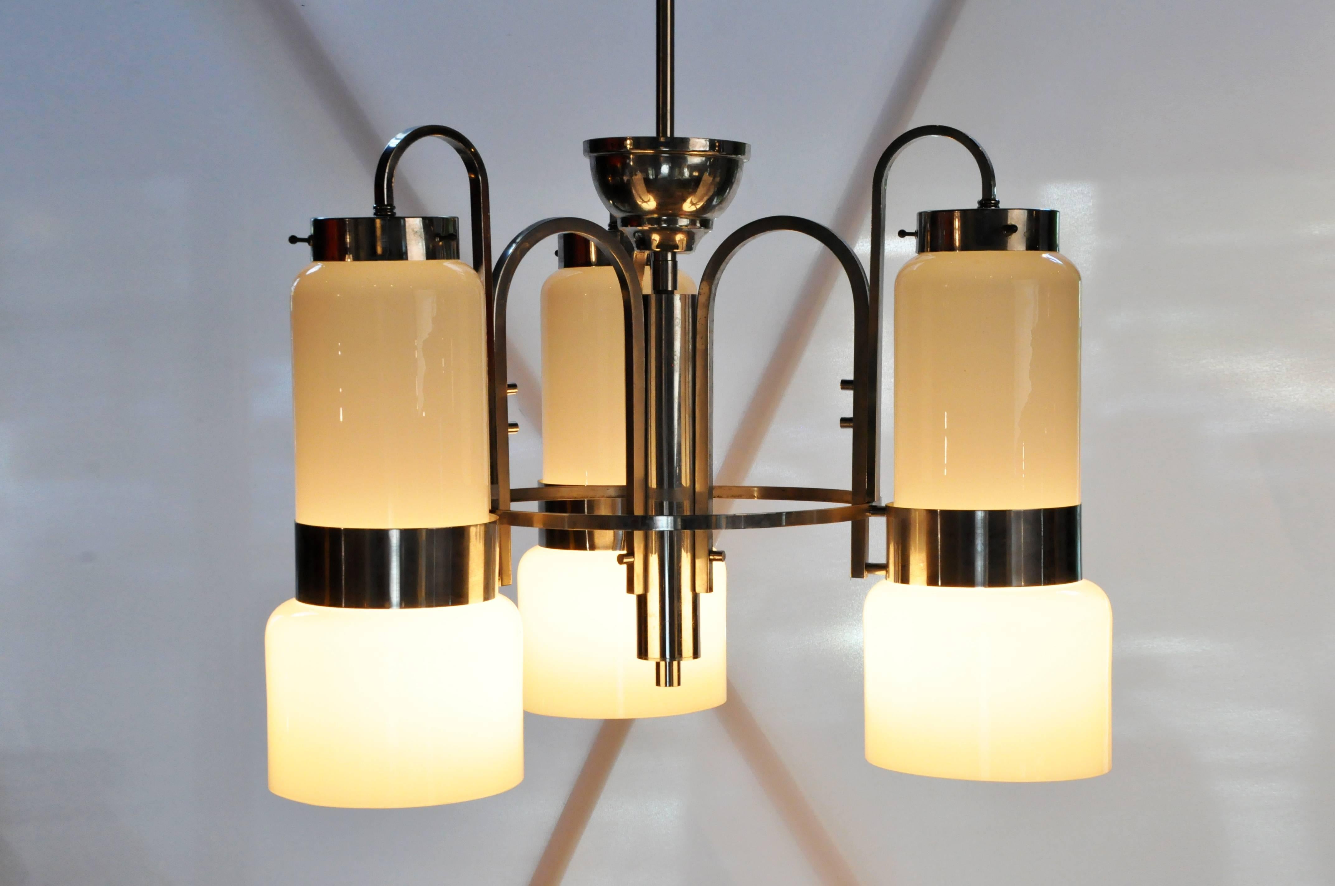 This stylish Mid-Century light piece is composed of a single tier of frosted glass cylinders mounted on a grid of concentric rings and metal arches. Both artistic and eclectic it imparts a fun, vintage vibe.