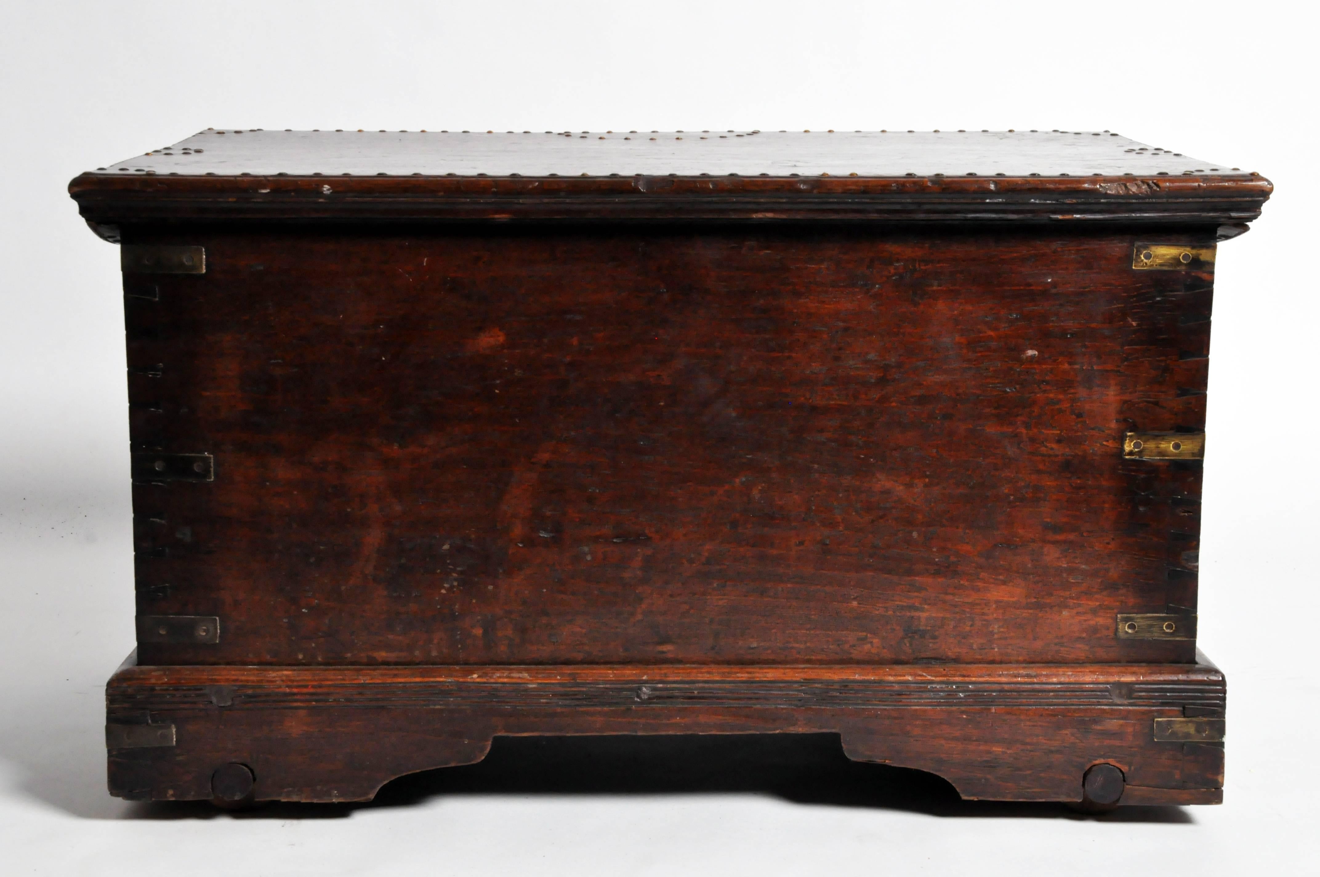 This handsome British Colonial trunk is from Rangoon, Myanmar and is made from teak wood. Made in early the 20th Century this piece features nail head decorations and a beautiful aged patina. 