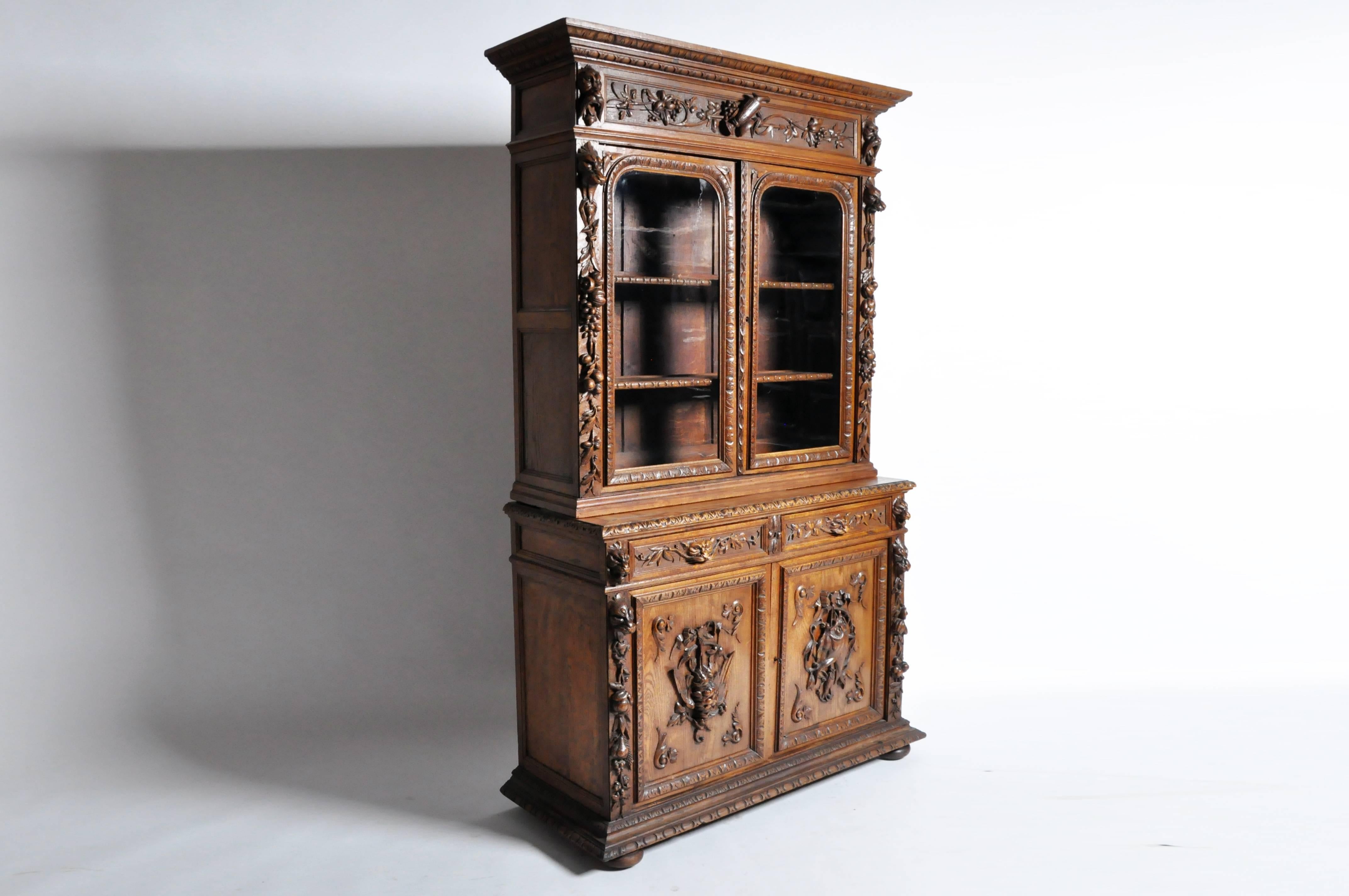 As opulent as it is well-made, this massive oak cabinet hails from Northern France and was likely commissioned during the mid-late 1800s when the vogue for the hunting style in Europe underwent a revival. Featuring intricately hand-carved harvest