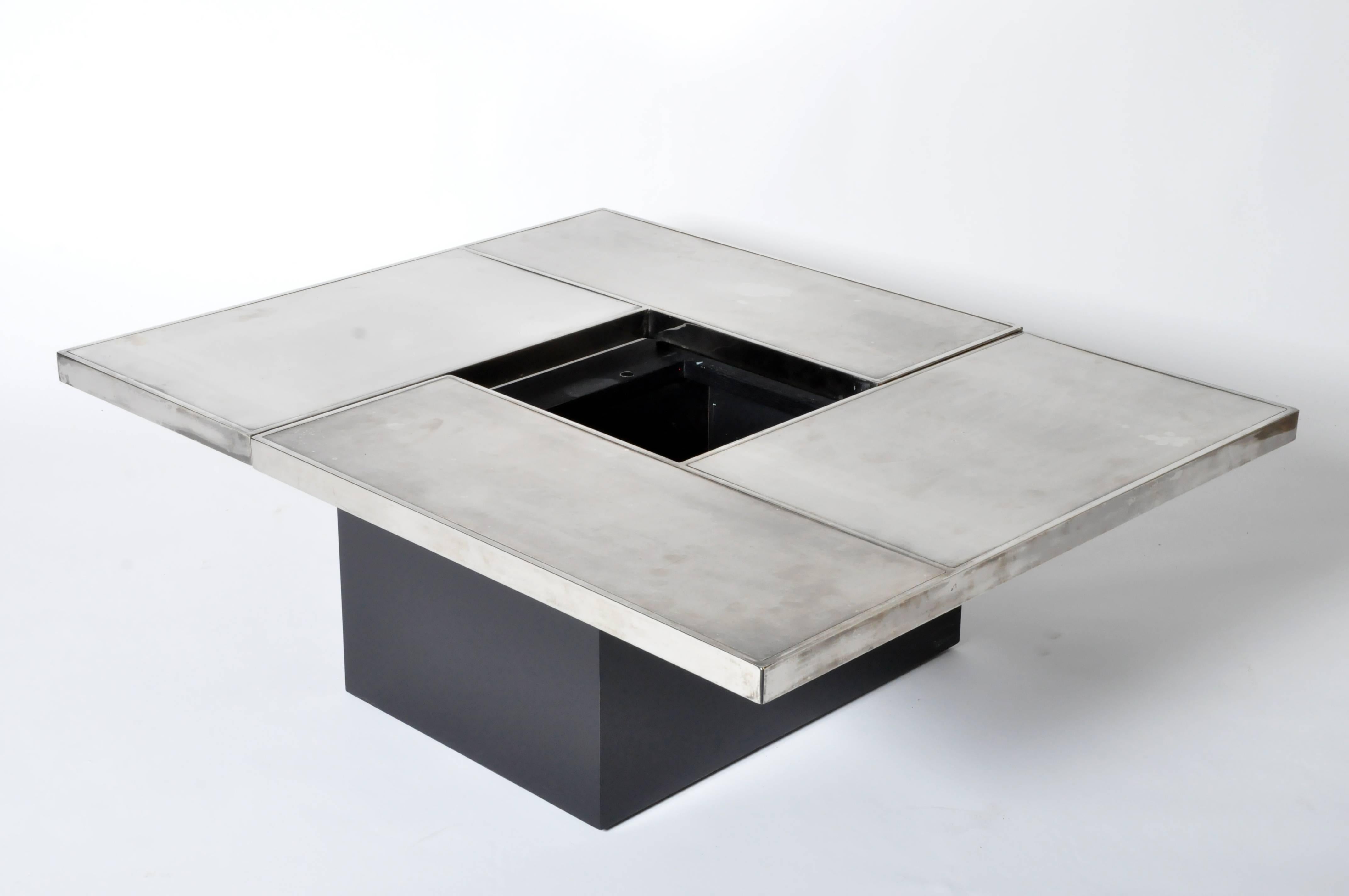 This elegant convertible coffee table also functions as a mini bar. It is from Belgium and is made from wood and silver plated metal, circa 1970.