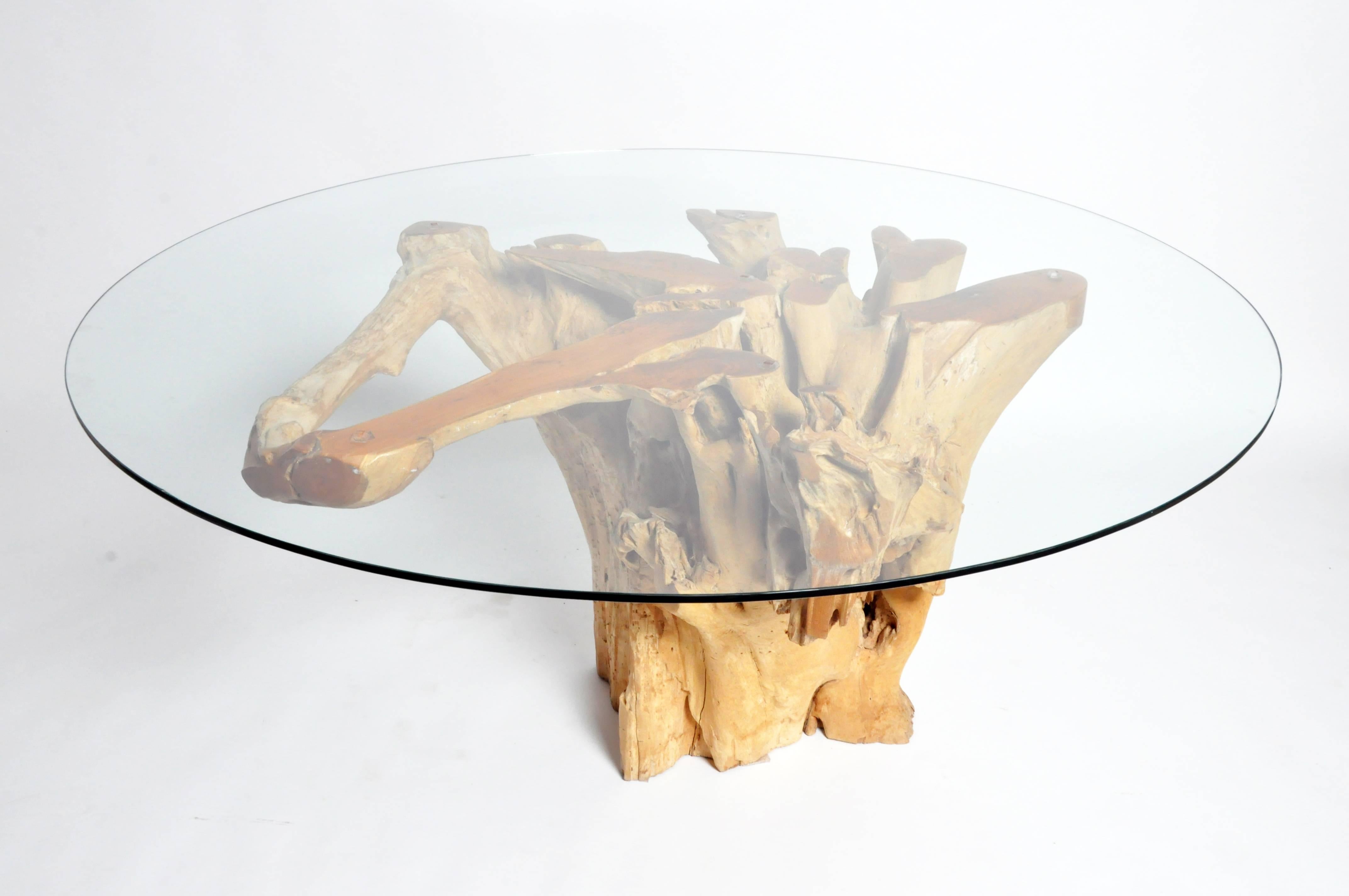This pedestal was cut from a old teak stump and root. The tabletop is cut from the root and bottom was the stump of the tree. The tree was harvested in the early 20th century and the stump left in the ground; it was considered of little value. Since