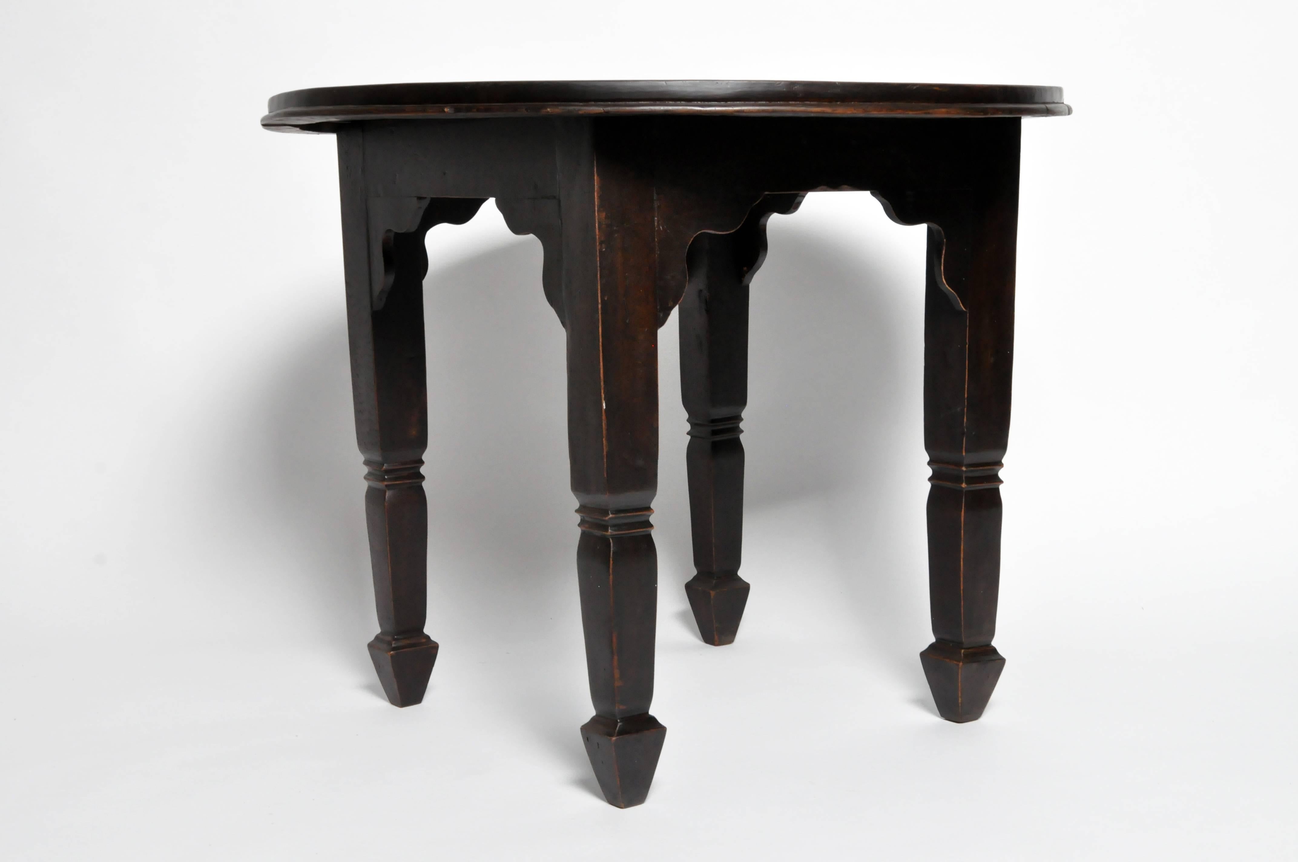 This British Colonial Burmese round table is from Rangoon, Burma and is made of teak wood with black lacquer, circa 1920.