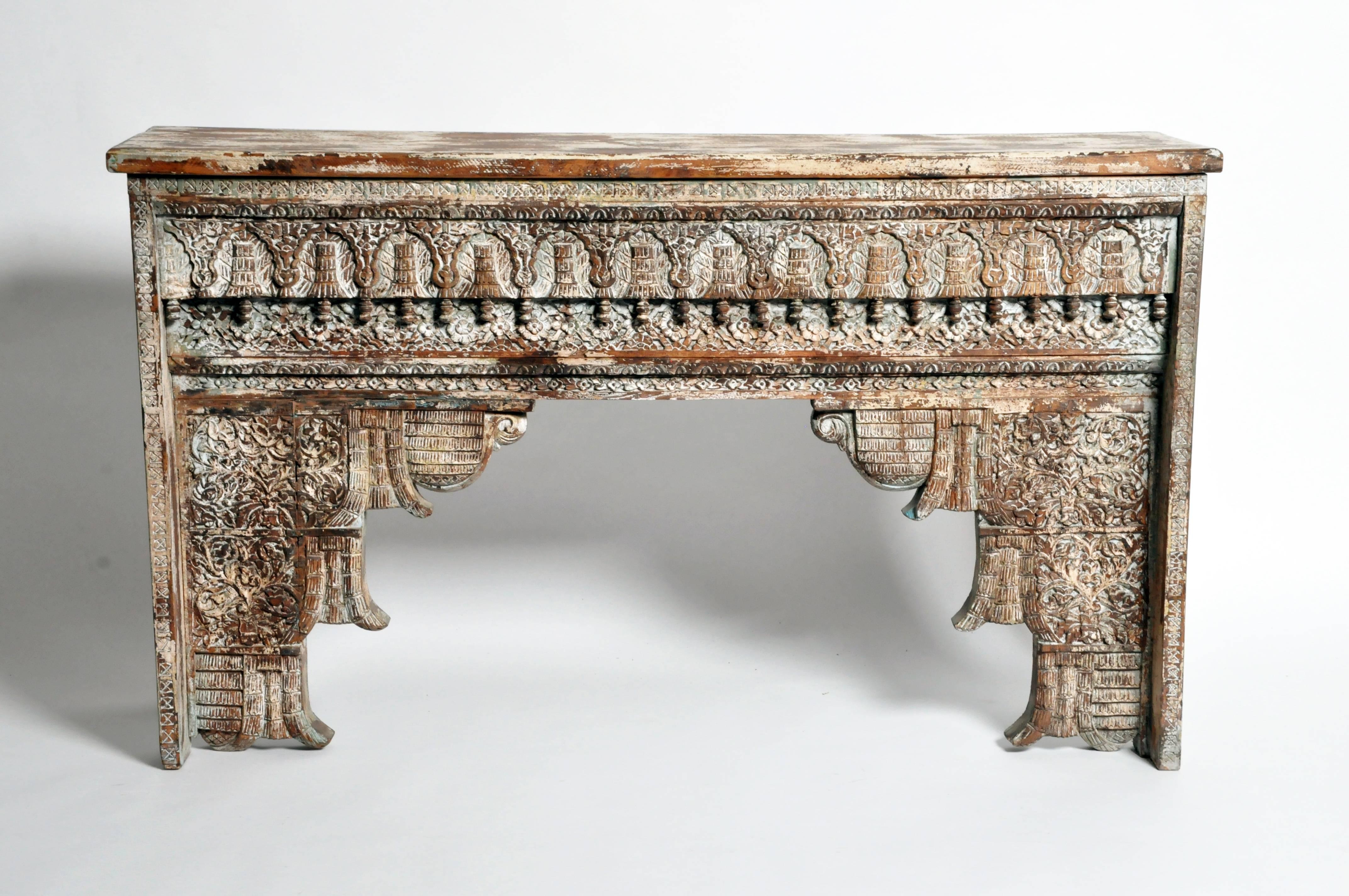 This impressive British Colonial console is from Gujarat, India and is made from sheesham wood, circa 1900. It features beautiful hand-carved details and a beautifully aged patina.