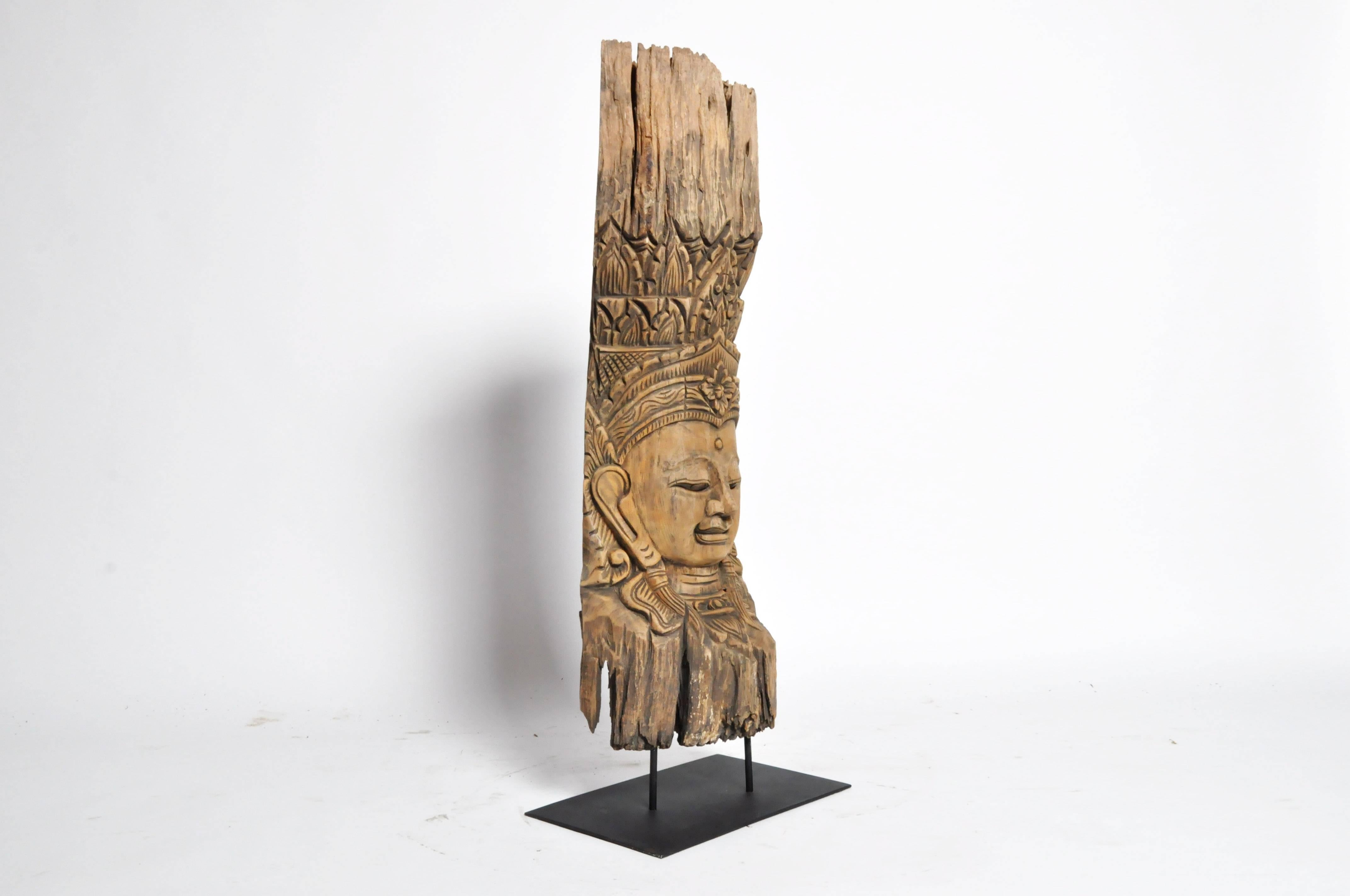 Recently carved from a reclaimed piece of teak wood, this bust takes the form of an Apsara. Traditionally found in Hindu and Buddhist mythology, Apsaras are female spirits of the clouds and waters. These Goddesses are found throughout Cambodia,