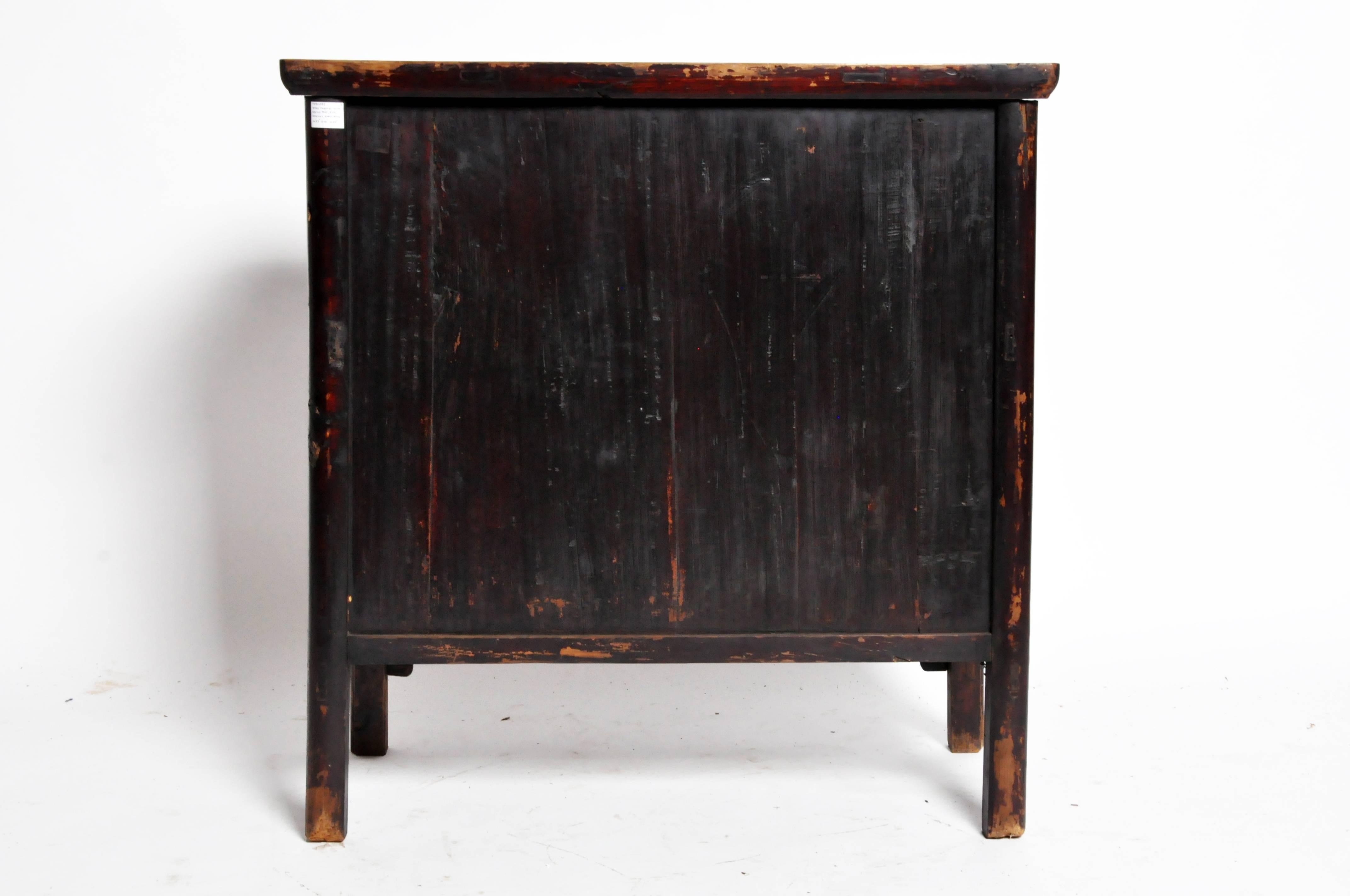 This Chinese round post chest is from the early Qing dynasty and is made from elmwood. It features two drawers and its beautifully aged original patina.