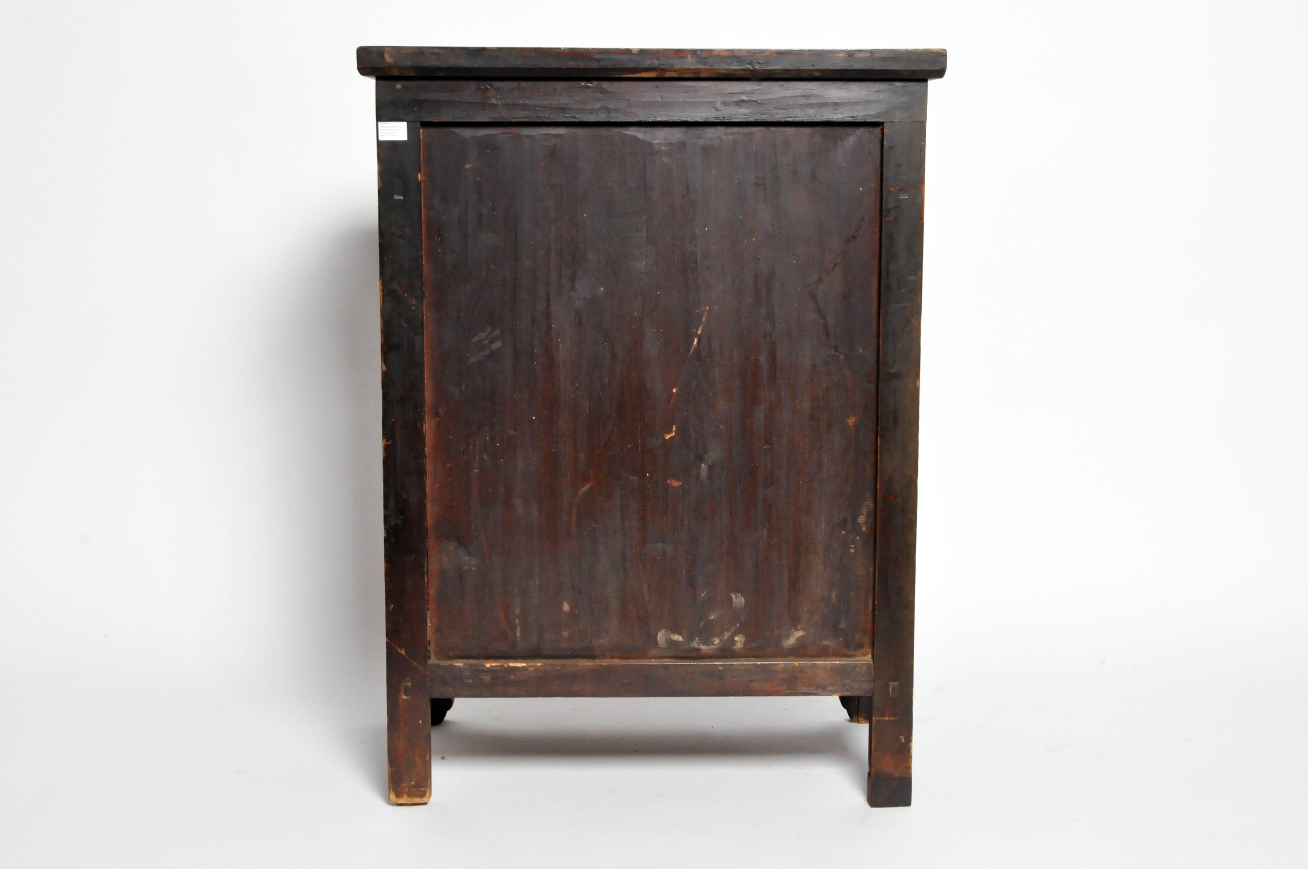 This handsome cabinet is from Gun Zhu, China and was made during the late Qing dynasty. Made from elmwood with a burl front it features two drawers and a shelf inside.