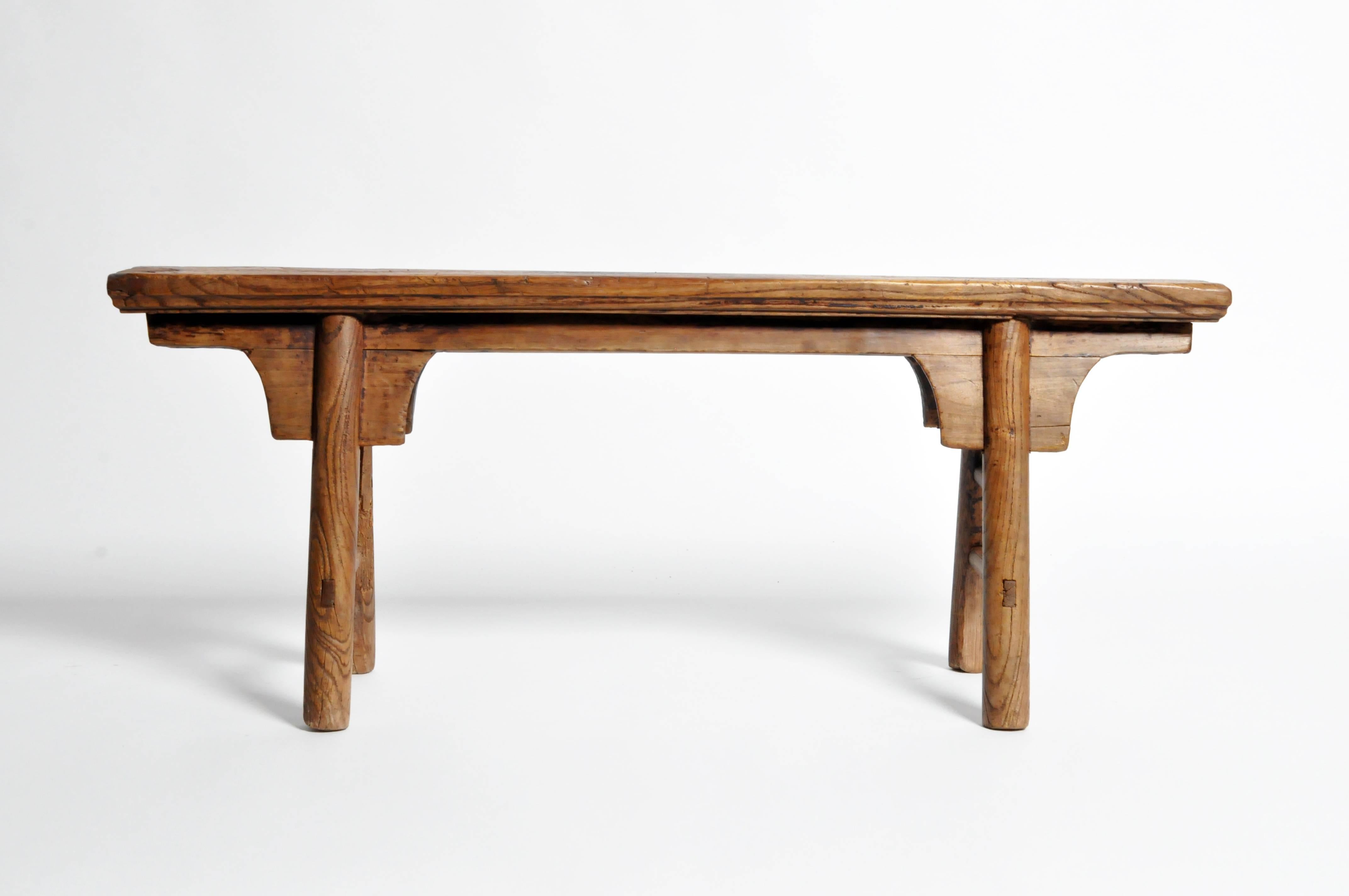 An elmwood bench from Shandong, China that dates back to the Middle Qing dynasty.