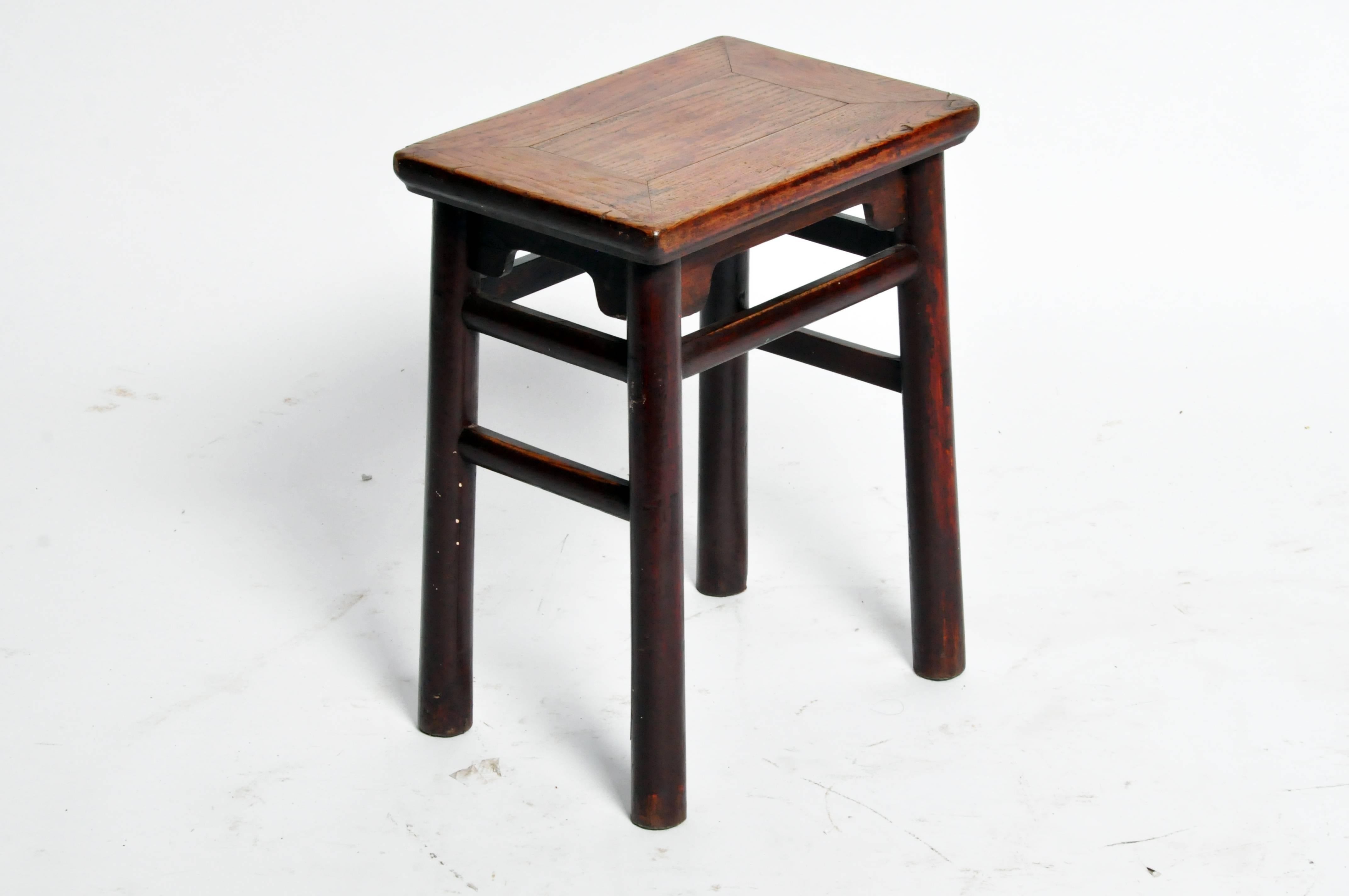 This handsome Qing dynasty Chinese stool is from Shandong, china and was made from elmwood. It features round posts designed, simple stretchers, and original lacquer.