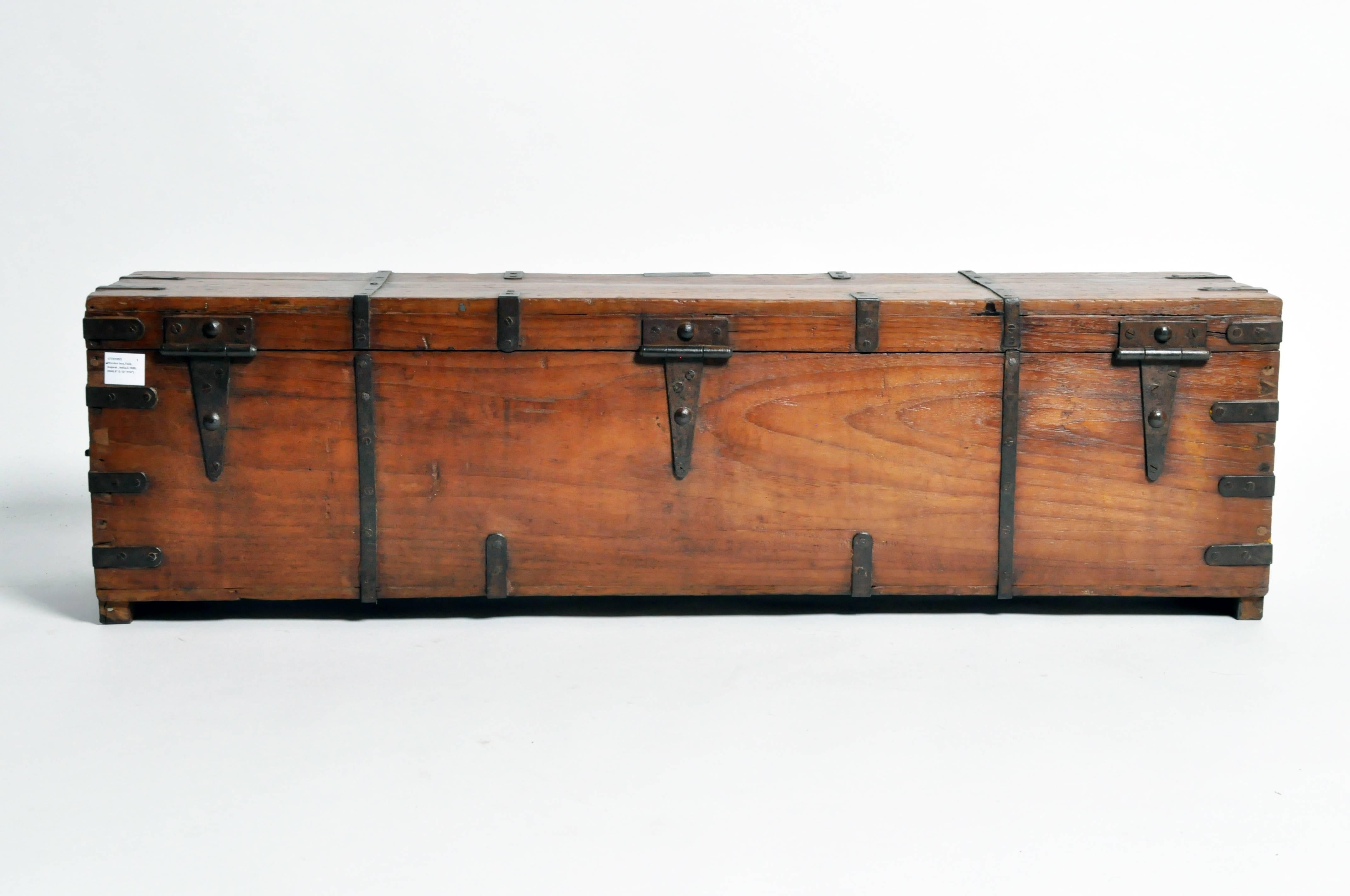 This vintage rifle box is from Gujarat, India and is a reinforced strongbox made from teak wood with hand-forged iron banding, circa 1920.