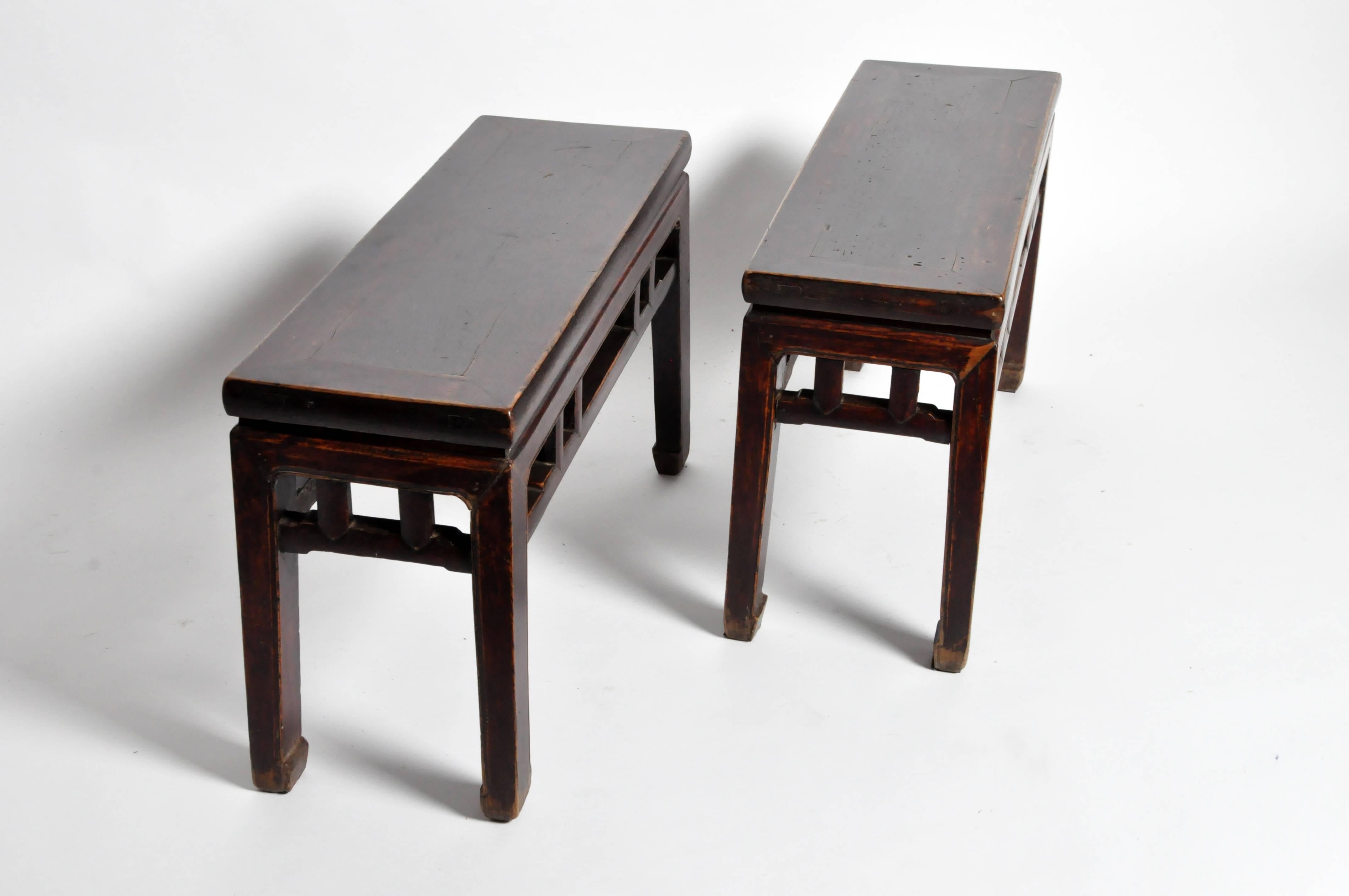 These Qing dynasty rectangular Chinese benches are from Shanxi, China and are made from Walnut. They feature horse hoof legs and original lacquer.