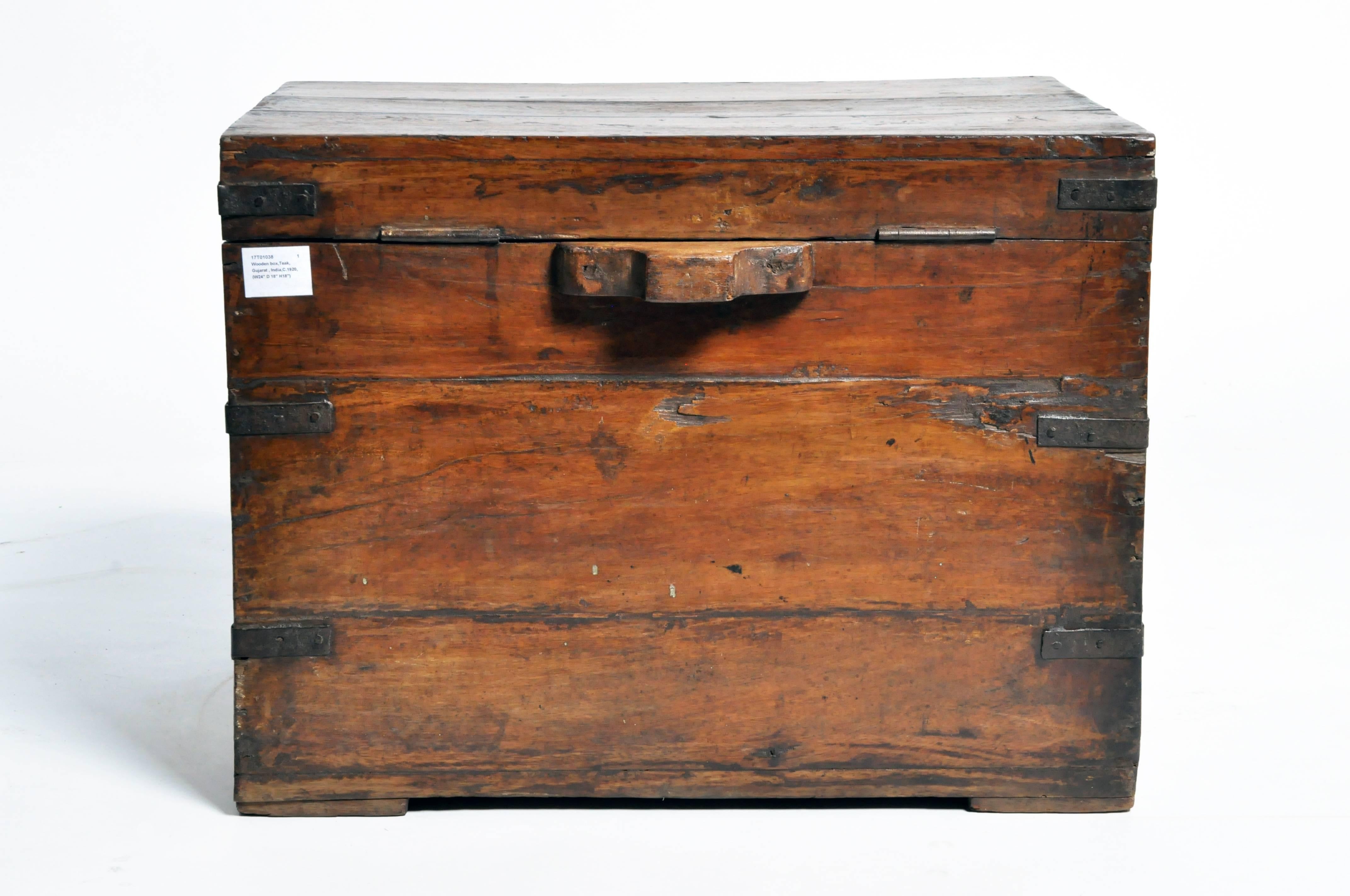 This storage box is from Gujarat, India and was made from teak wood and hand-forged iron branding, circa 1920.