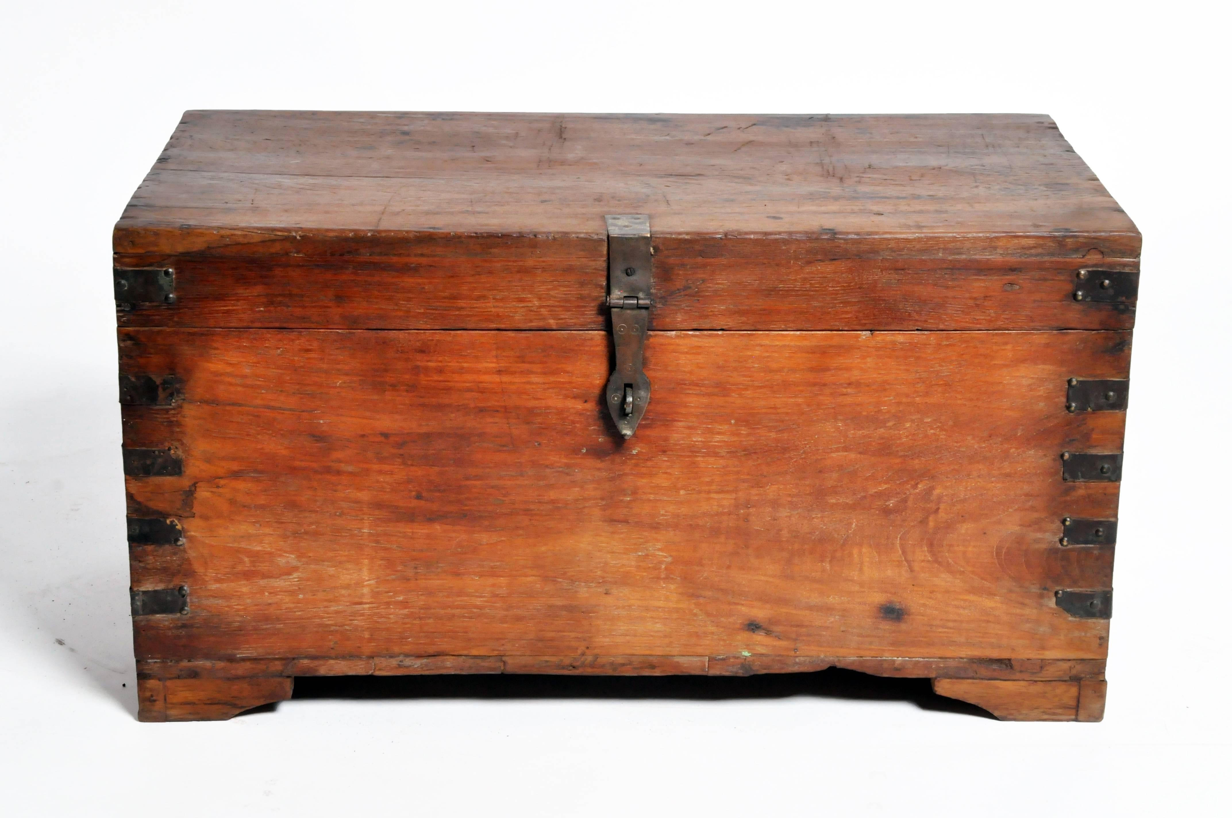 This storage box is from Gujarat, India and was made from teak wood and hand-forged iron branding, circa 1940.