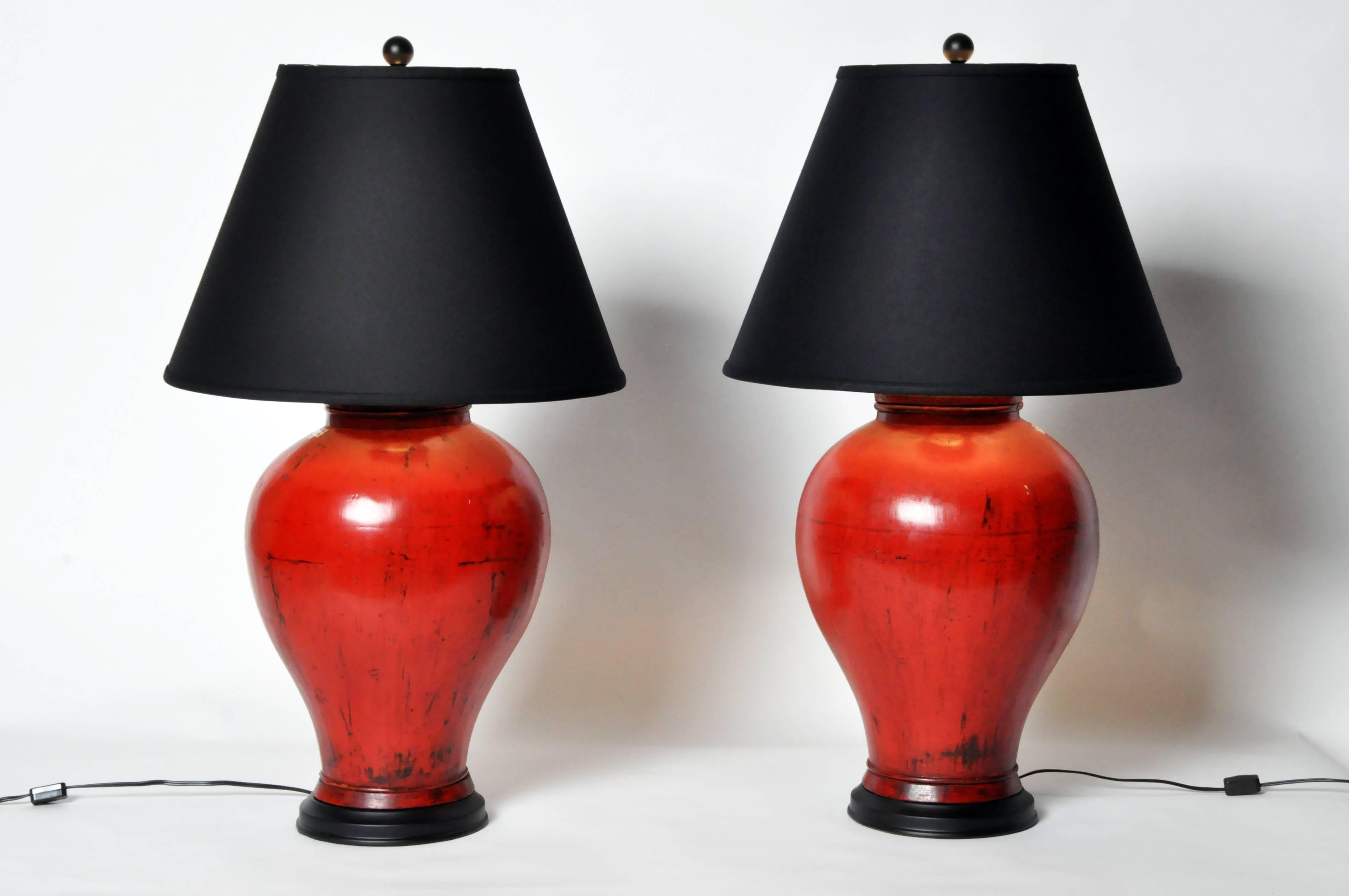This handsome canister, with ovoid-form body that tapers to the foot, has been retrofitted by our workshop and transformed into a lamp. Shown in a pair for styling; each is sold individually and has its own unique deep, antiqued red finish.