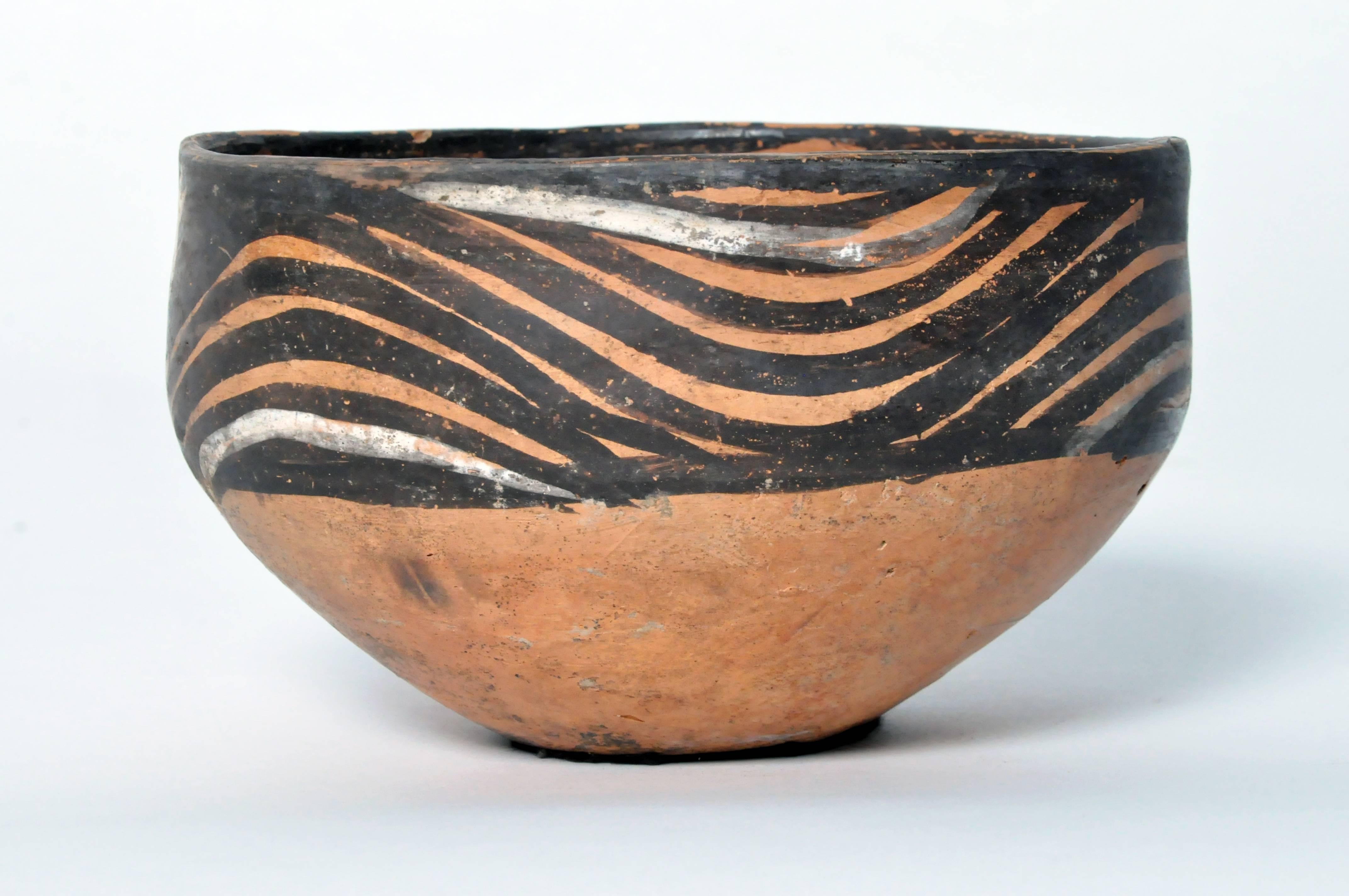 This bowl was made in the Yangshao culture and is of the Ma-chia-yao type. This culture thrived in the northwestern part of China along and around the Yellow River between 3000 B.C. and 1700 B.C. The piece is in very good condition with no cracks to