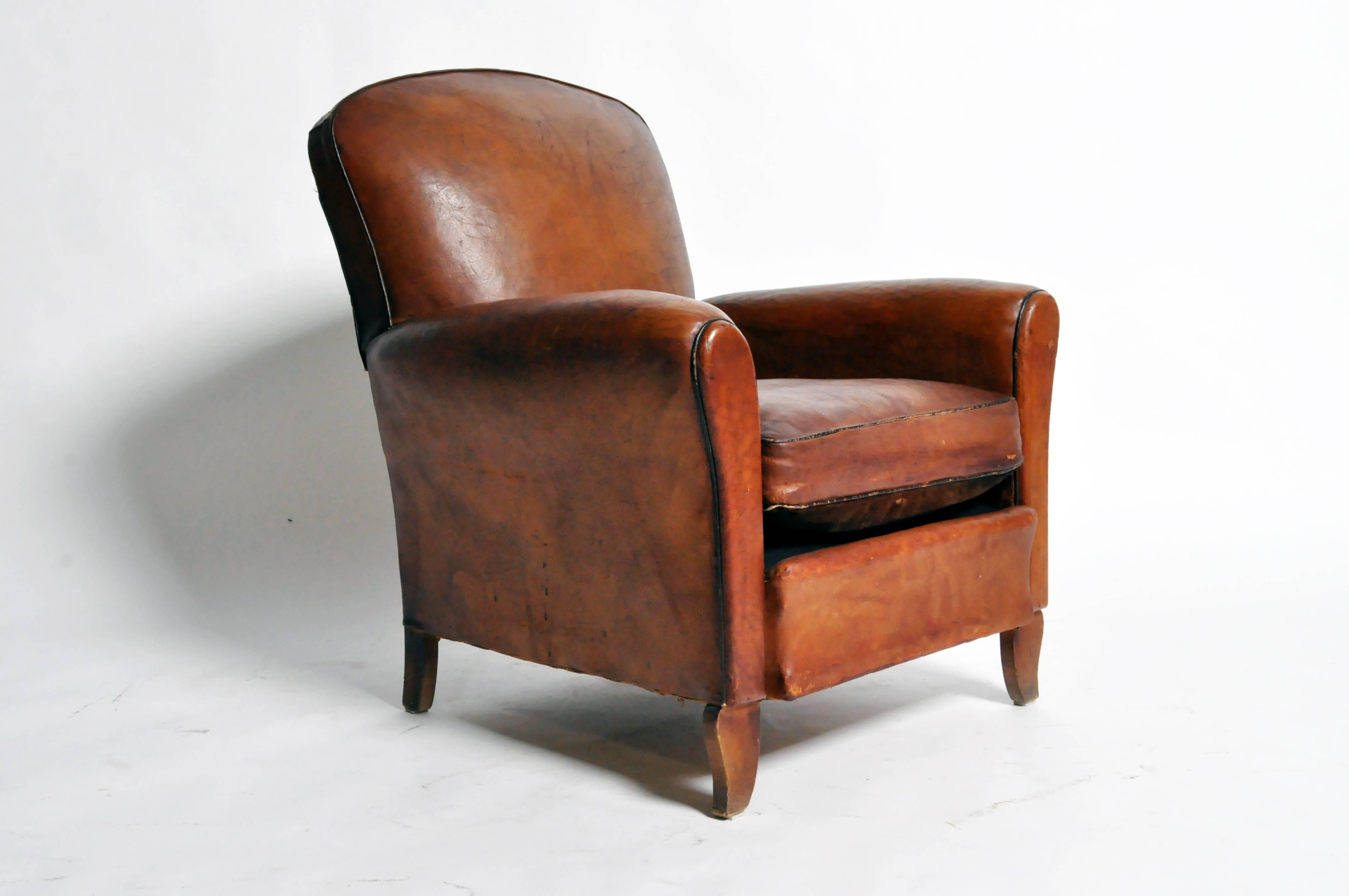 This handsome Art Deco leather chair is from Paris, France and was made from leather, c. 1940. The chair features its original leather, piping, and a beautifully aged patina. 

Additional dimensions: 18" Seat Width, 19" Seat Depth,