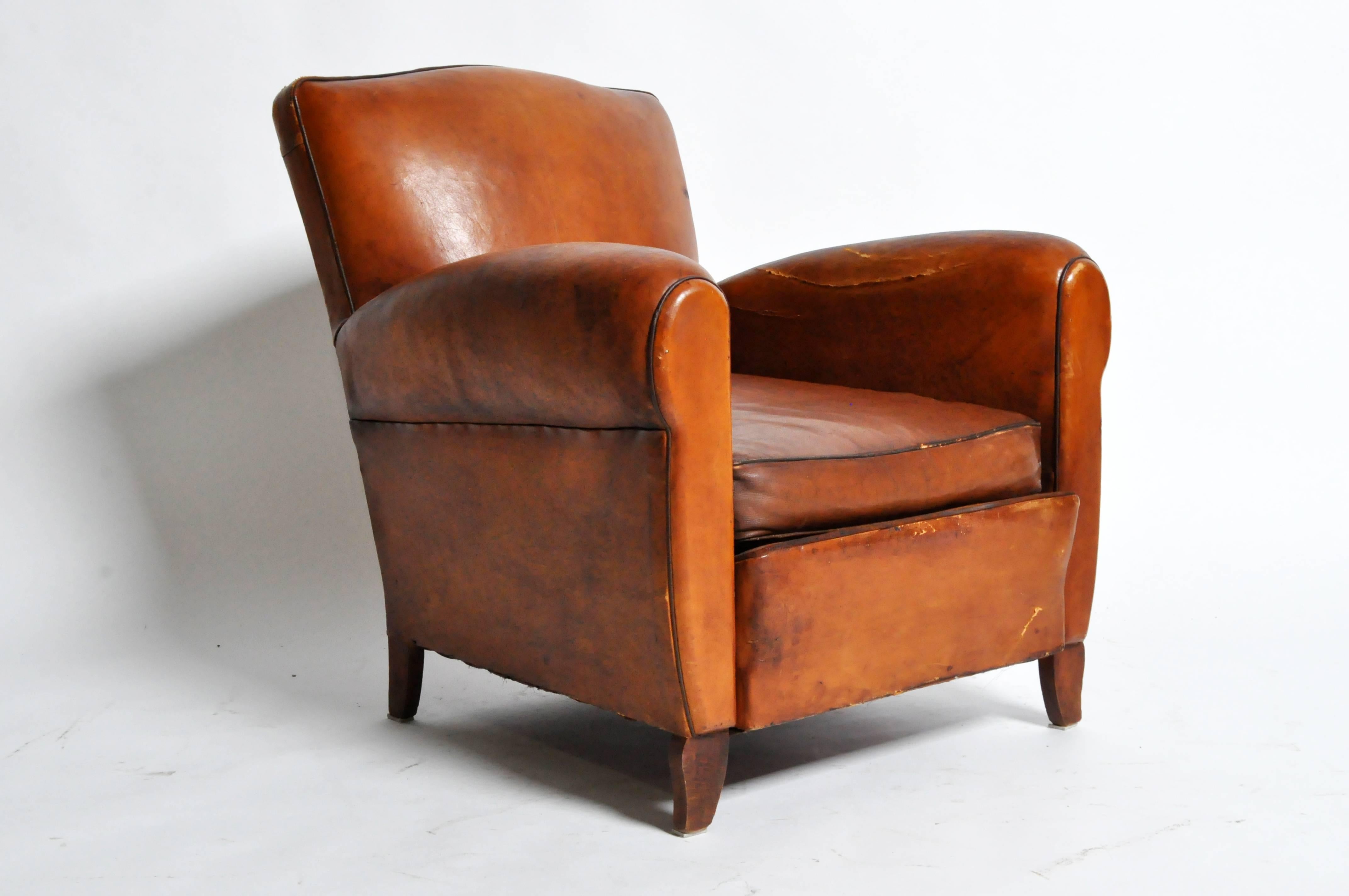 This handsome Art Deco leather chair is from Paris, France and was made from leather, c. 1940. The chair features its original leather, piping, and a beautifully aged patina. 

Additional dimensions: 20