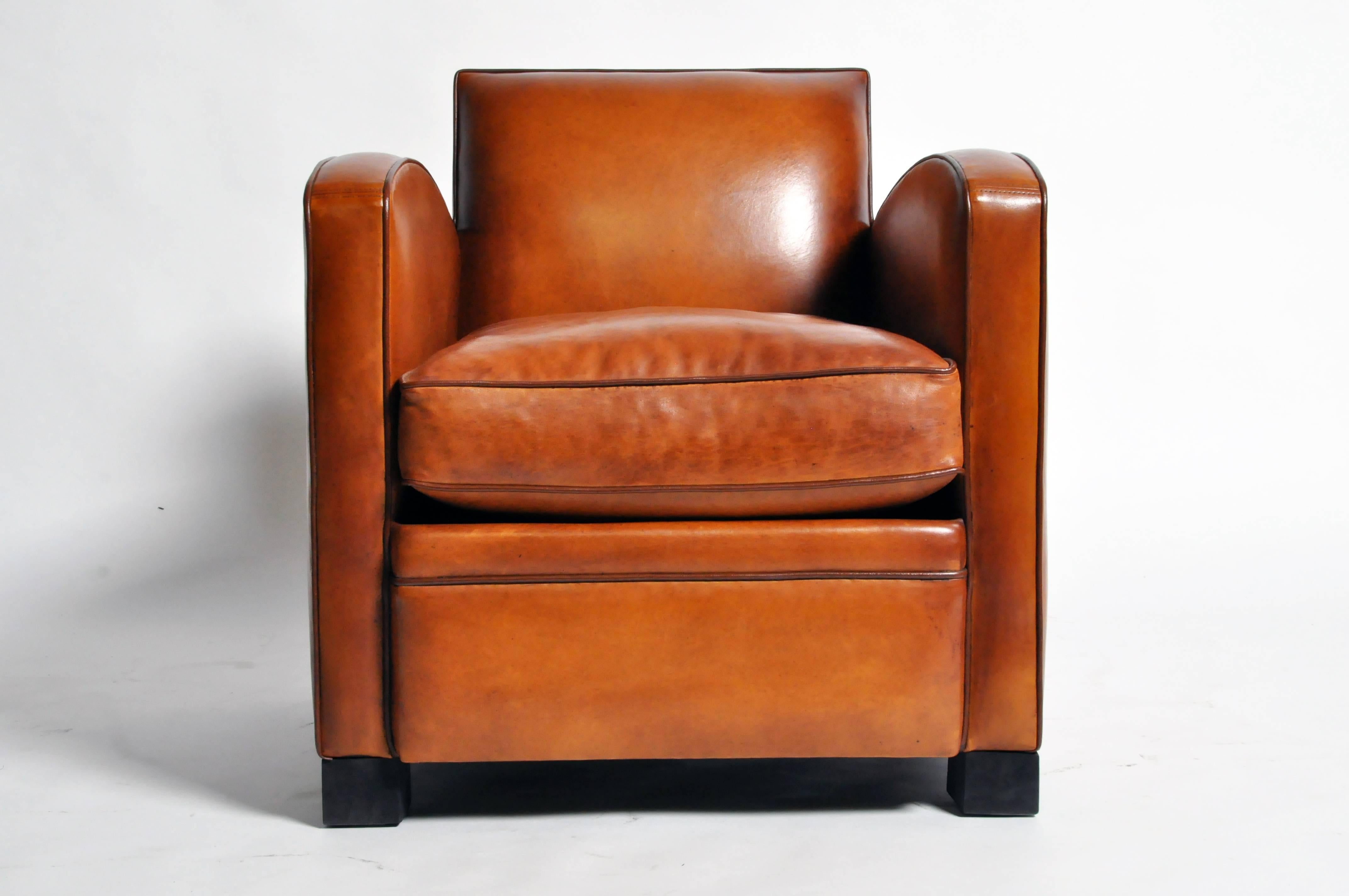 This handsome pair of newly made Parisian golden brown club chairs are from Paris, France and was made from lamb leather. They feature dark brown piping.

Additional Dimensions: 20.5" Seat Width, 21.5" Seat Depth, 24" Arm Rest Height,