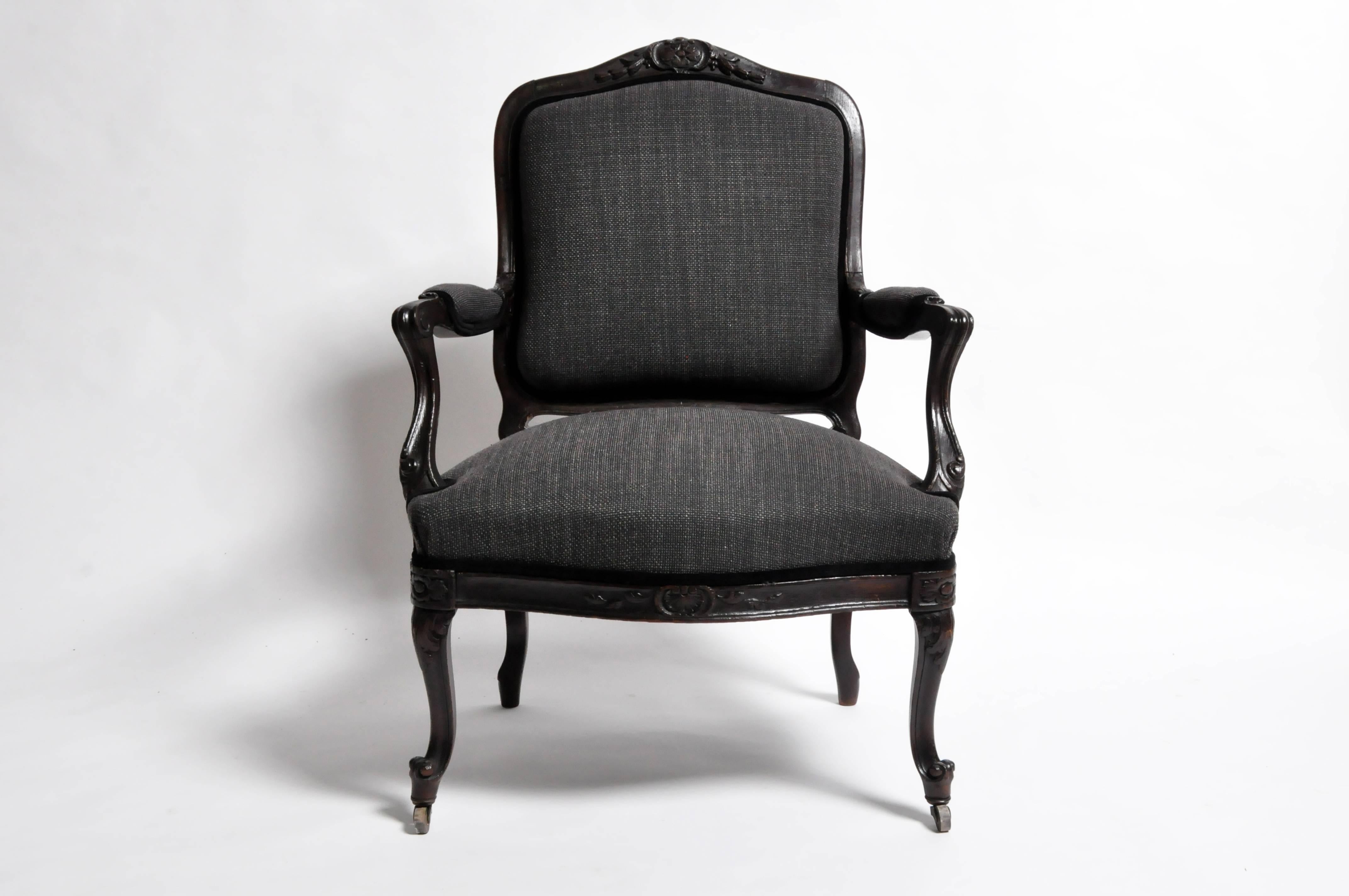 This handsome 19th Century set of four Louis XV style armchairs are from France and made from oak wood. They represents the perfect balance of old world sophistication and antique beauty. The chairs features a rich, dark wood frames, incised with