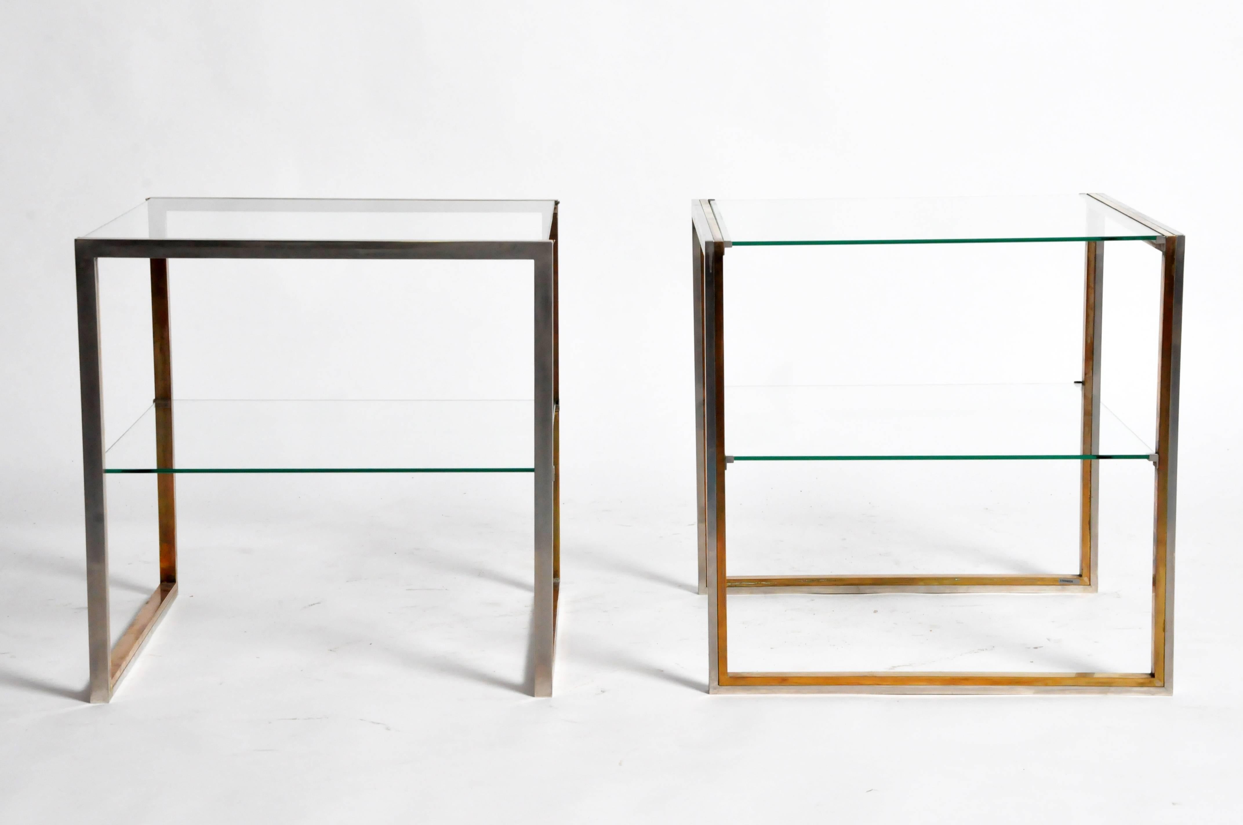 This elegant pair of side tables are from Paris, France and made from brass, chrome, and glass, c. 1970. They each feature a glass top and shelf for additional storage. 
