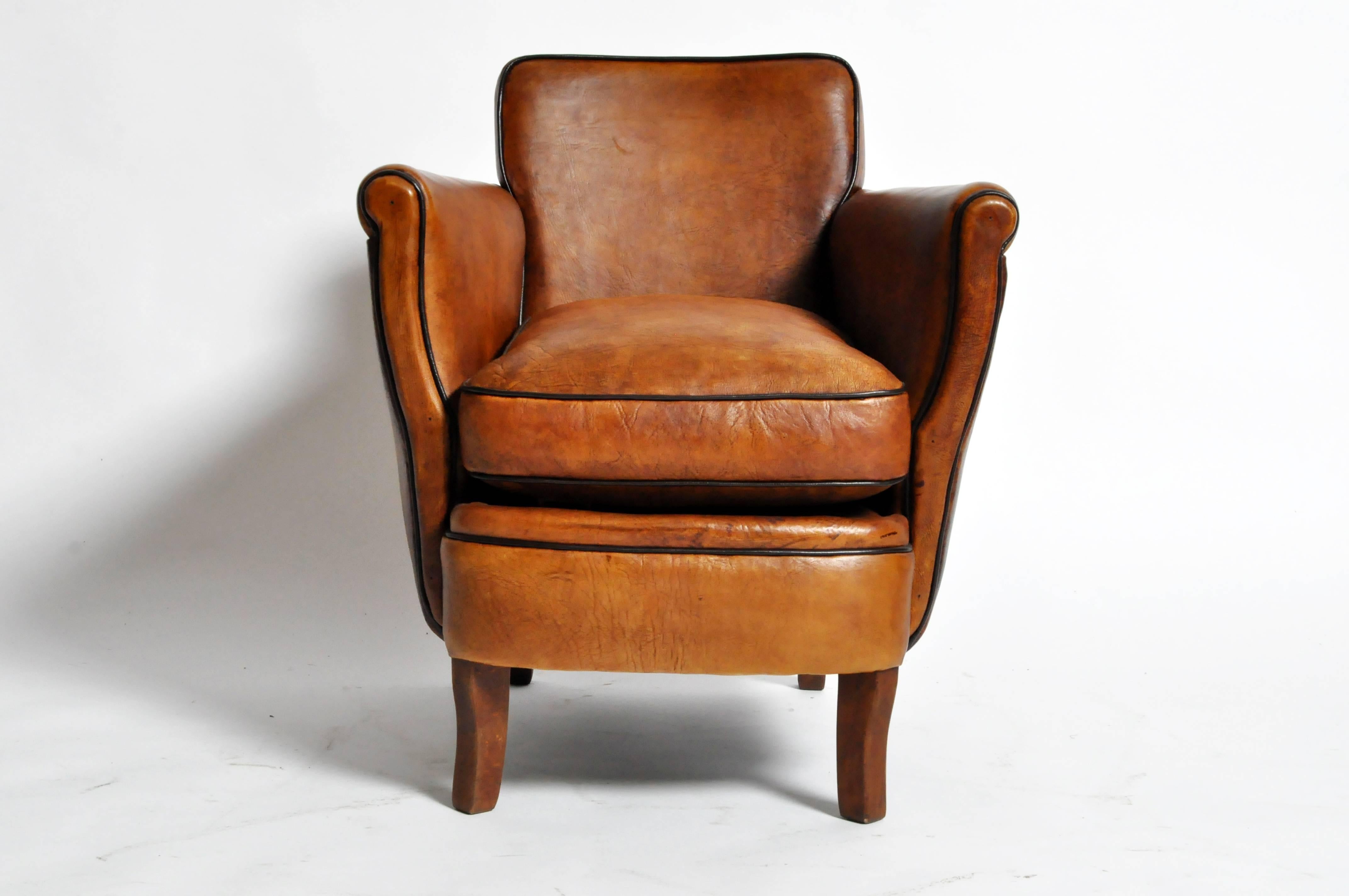 This pair of newly made "Submarine" brown club chairs are from Paris, France and was made from leather and wood. They feature dark brown piping and are highly comfortable.

Additional Dimensions: 17" Seat Width, 20" Seat Depth,