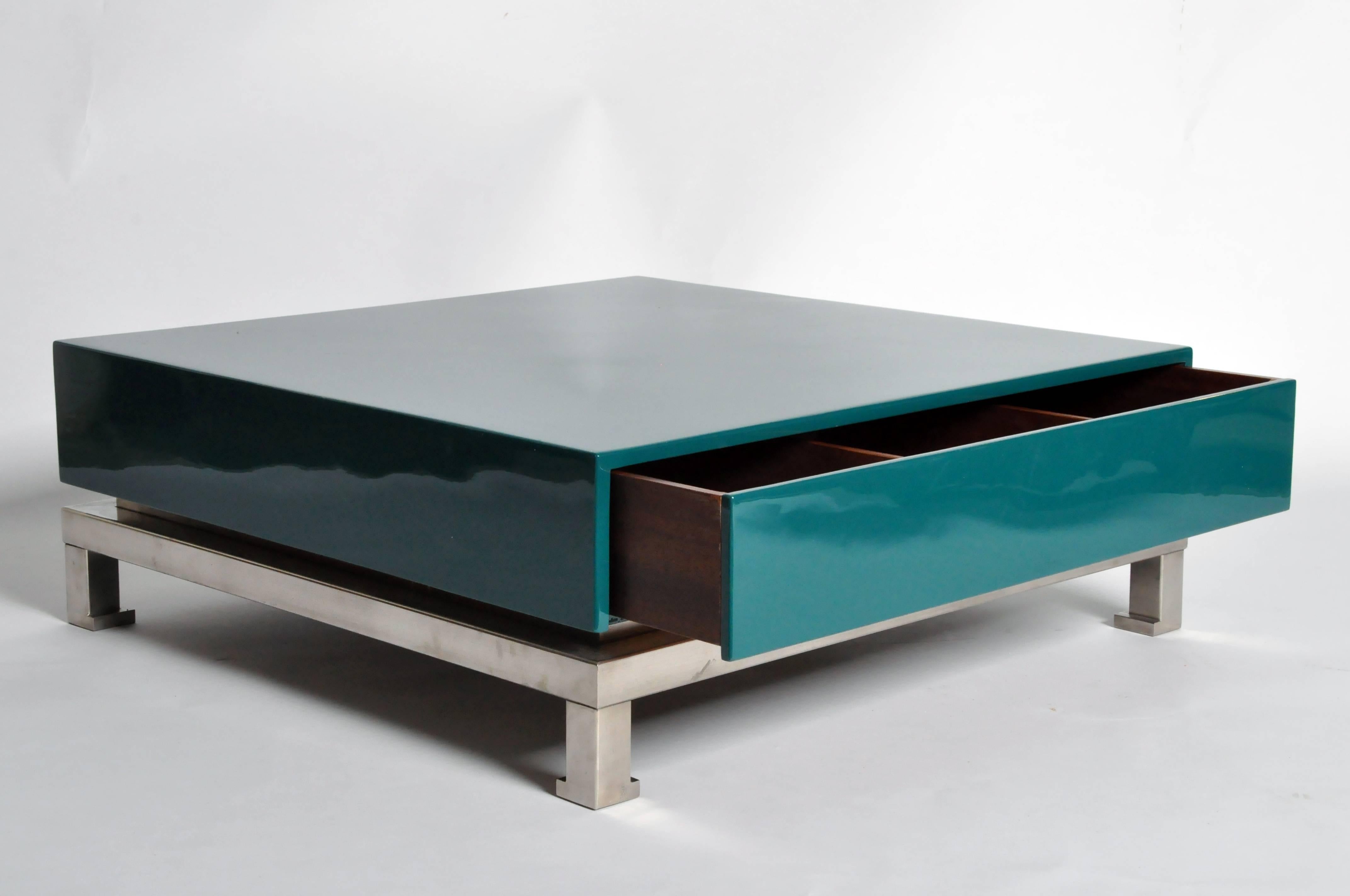 These glamorous low tables have pullout drawers hidden in their glossy teal lacquered bodies and are raised on hoofed feet.