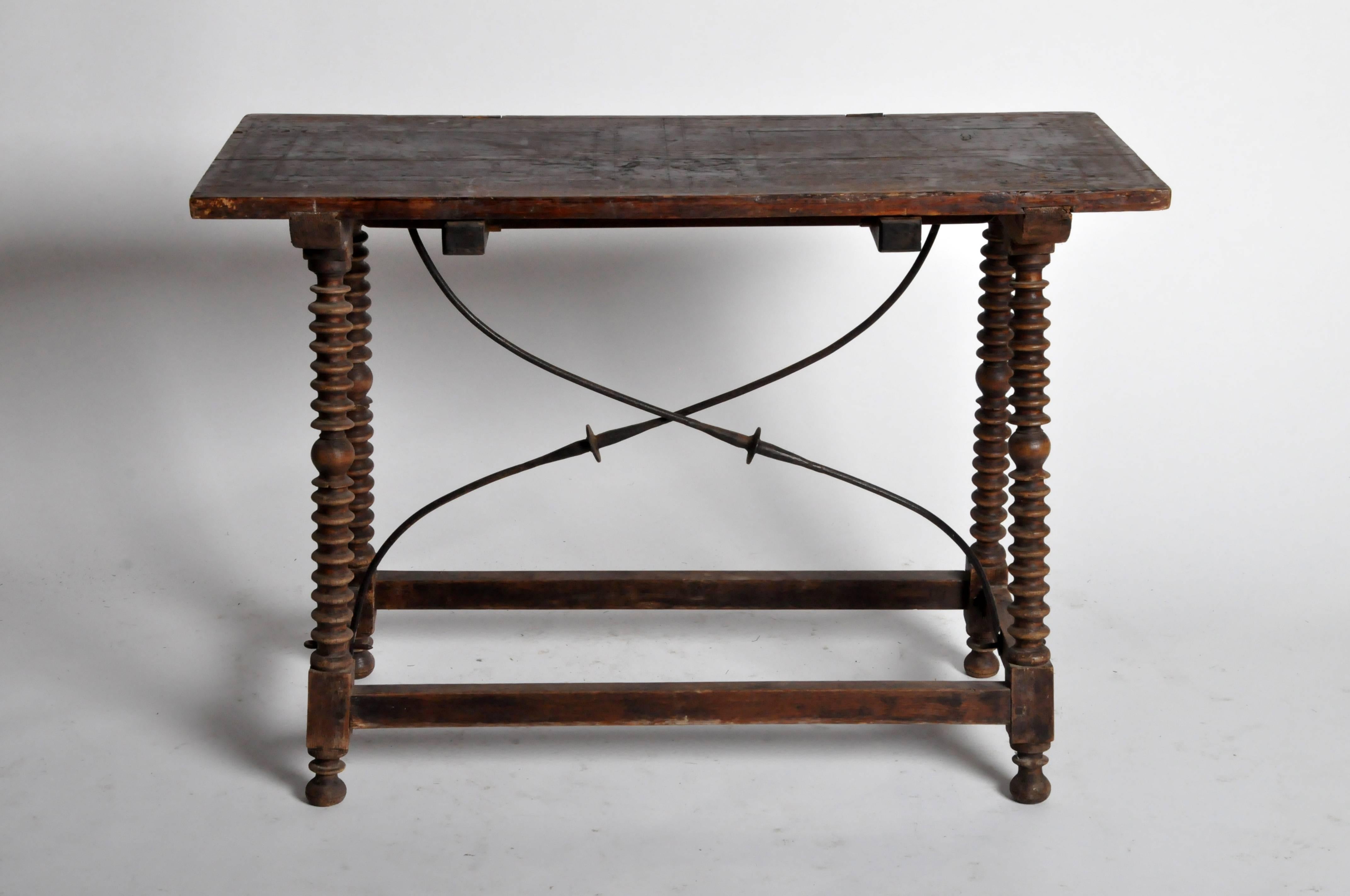 Based on of 17th century Spanish furniture, this Baroque style side table features bobbin turned legs and X-form curved iron stretchers.