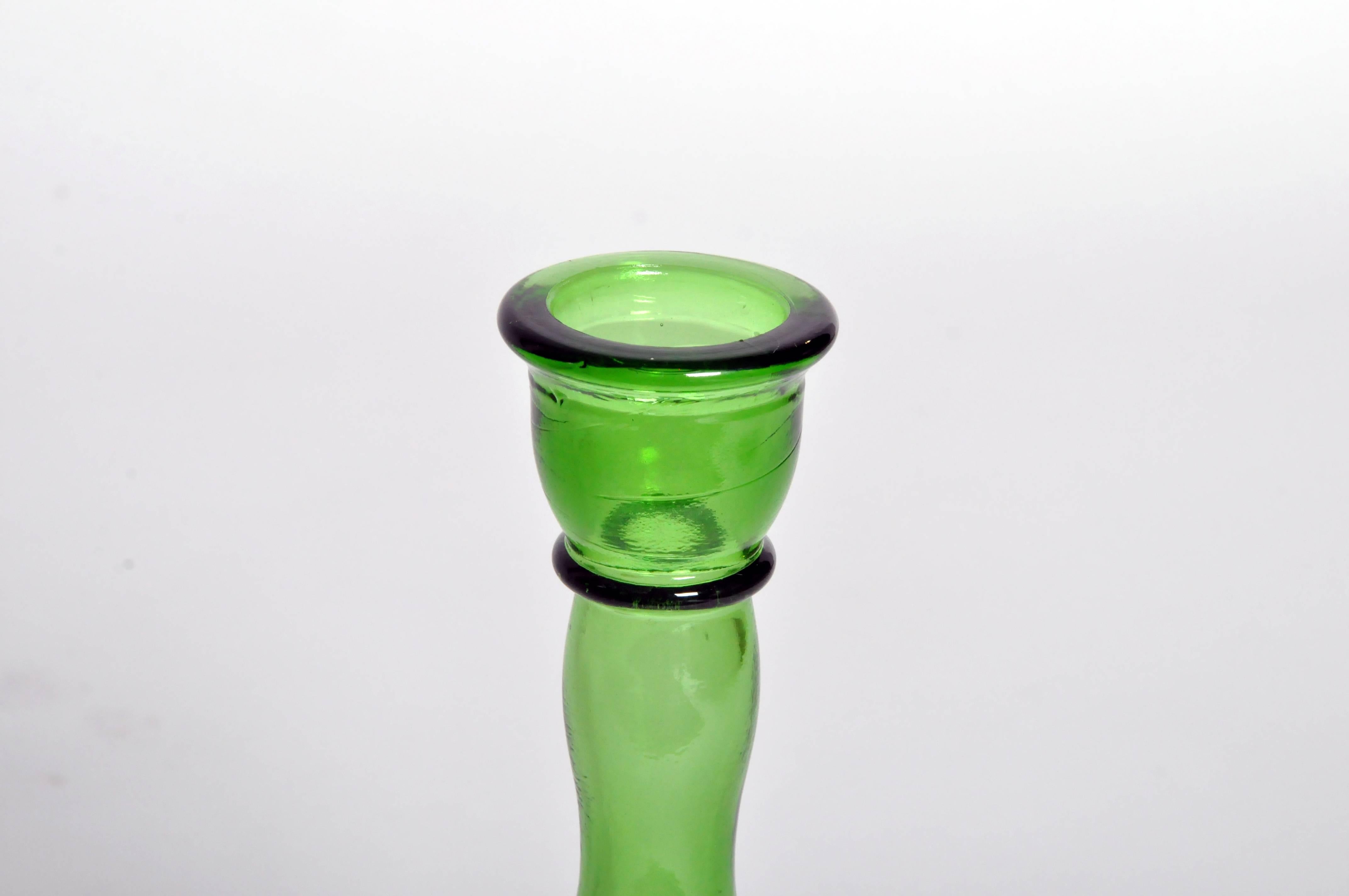Perfect for single stem blooms, these luminous emerald green vases are versatile and can also be used as candlesticks.