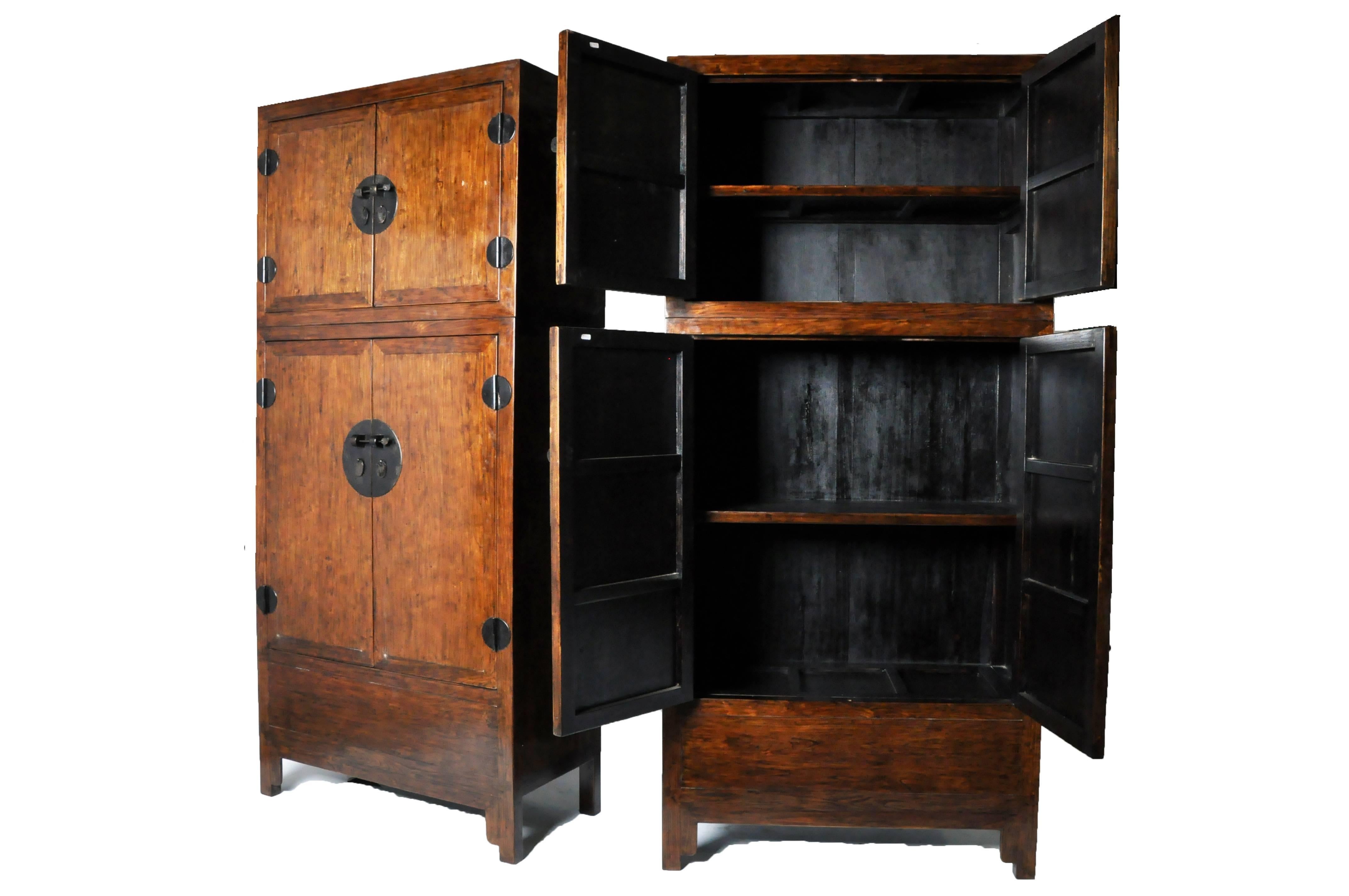 The square top, fitted with a single drawer, is raised over the lower chest, creating a middle display shelf. Double doors with metal lock plates and ring pulls conceal the additional storage space below.

Constructed with some pieces of reclaimed