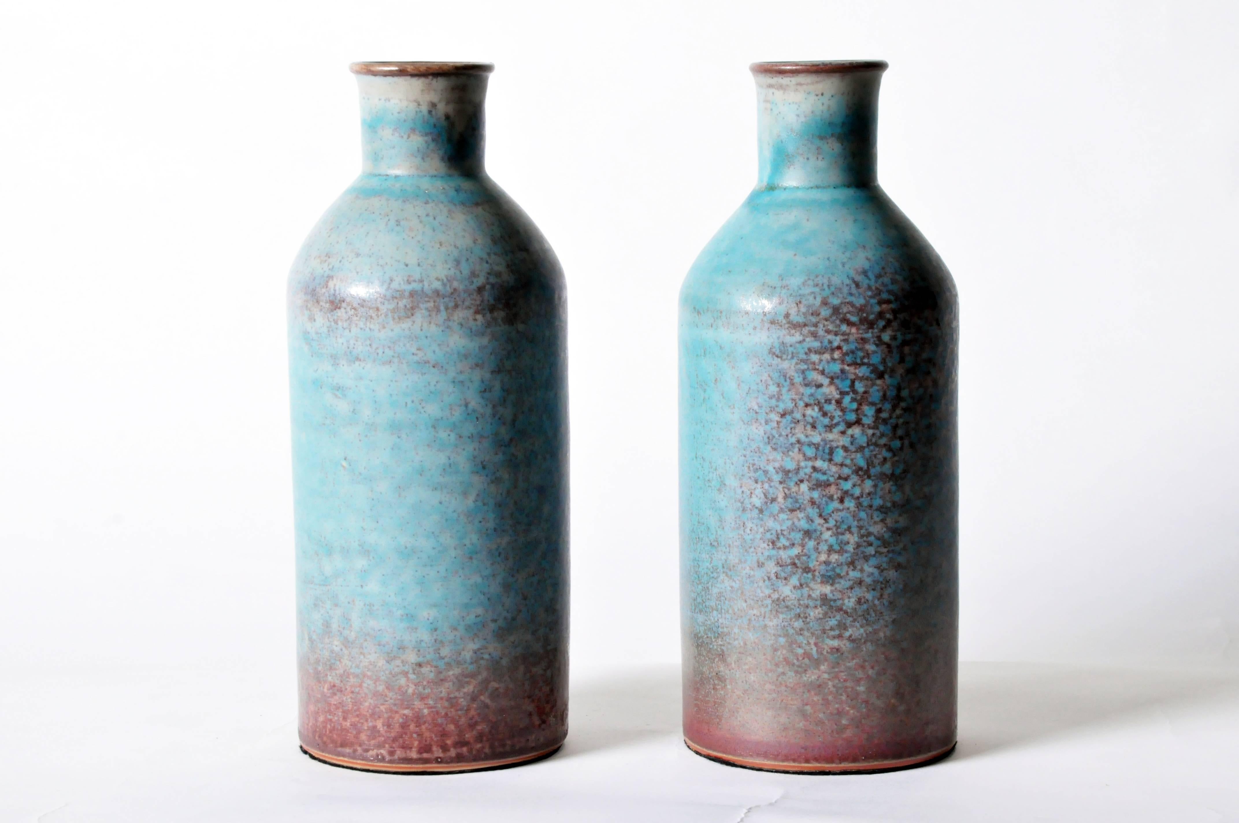This elegant handmade vessel features a multi-tonal glaze of matte turquoise dappled with purple. Each is sold individually; glaze patterns and coloring vary from vase to vase.