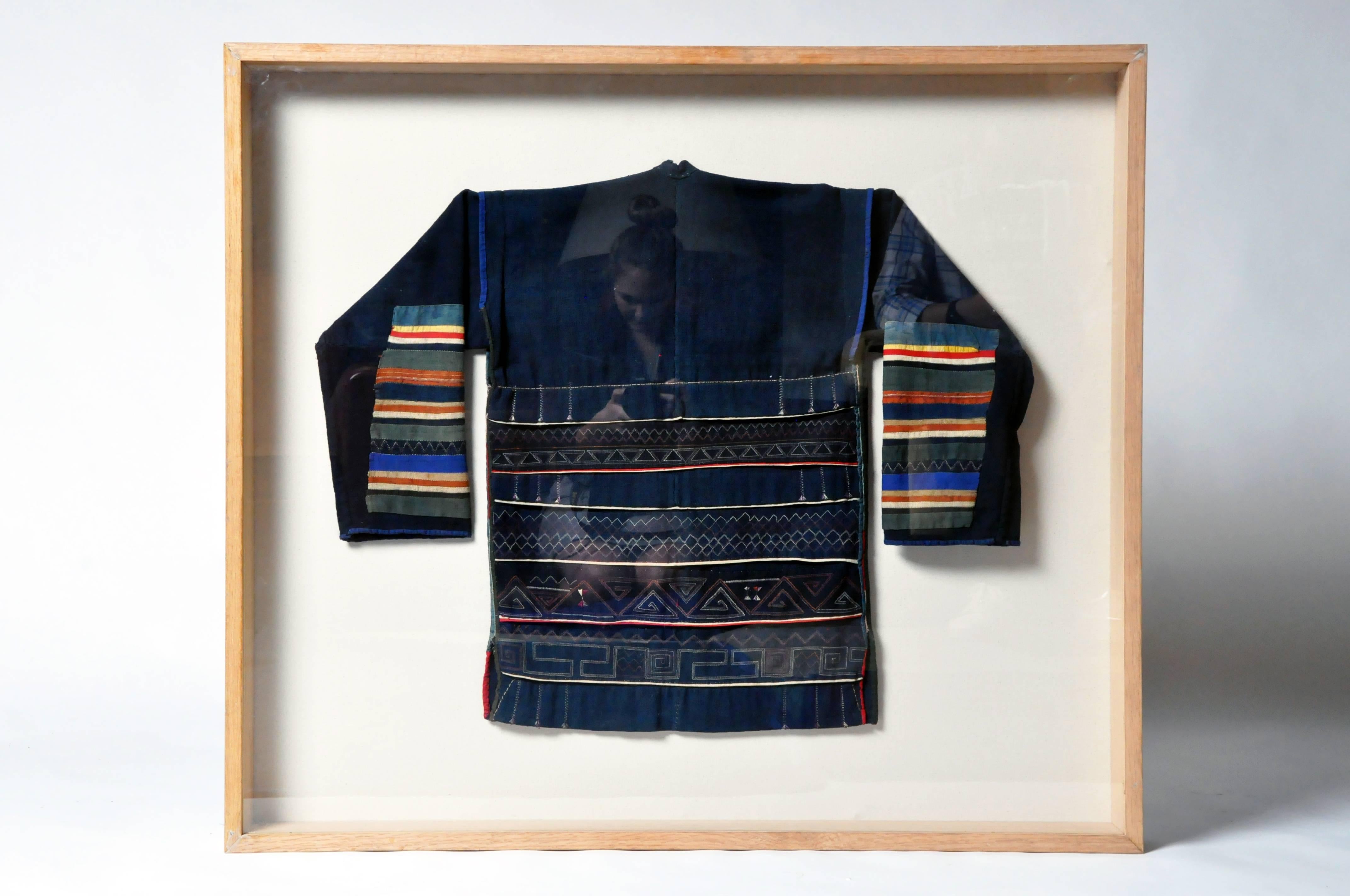 Framed man's jacket from the Akha Tribe. The Akha are an indigenous hill tribe who live in small villages at higher elevations in the mountains of Thailand, Burma, Laos, and Yunnan Province in China. They made their way from China into Southeast