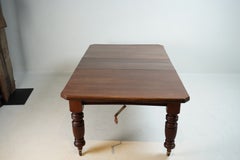 A British Colonial Dining Table on Casters with Extension Leaves